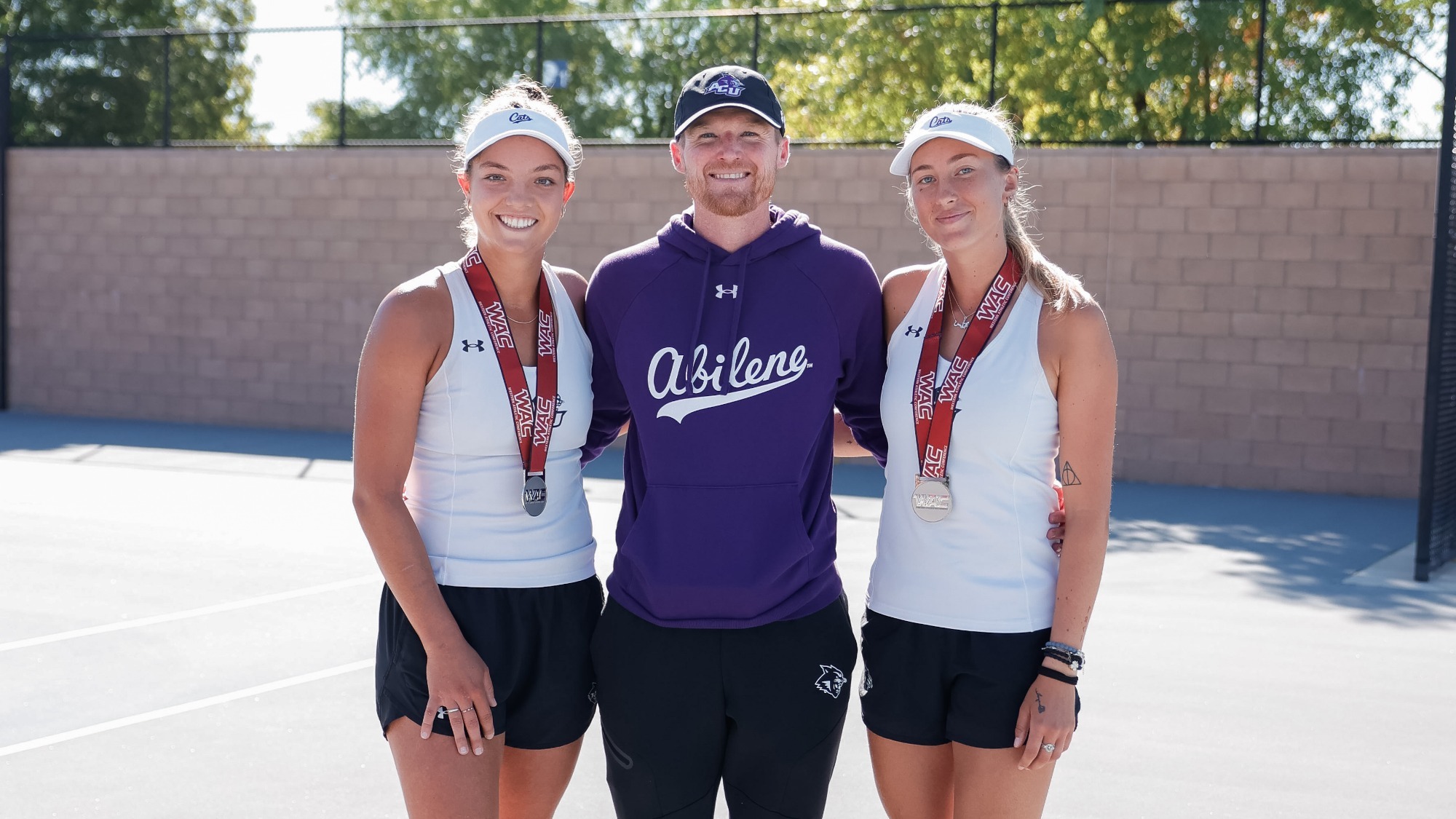 ACU women's tennis head coach Bryan Rainwater and players Masha Vrsalovic and Alice Klinteby at the WAC Tennis Invitational on October 18, 2025