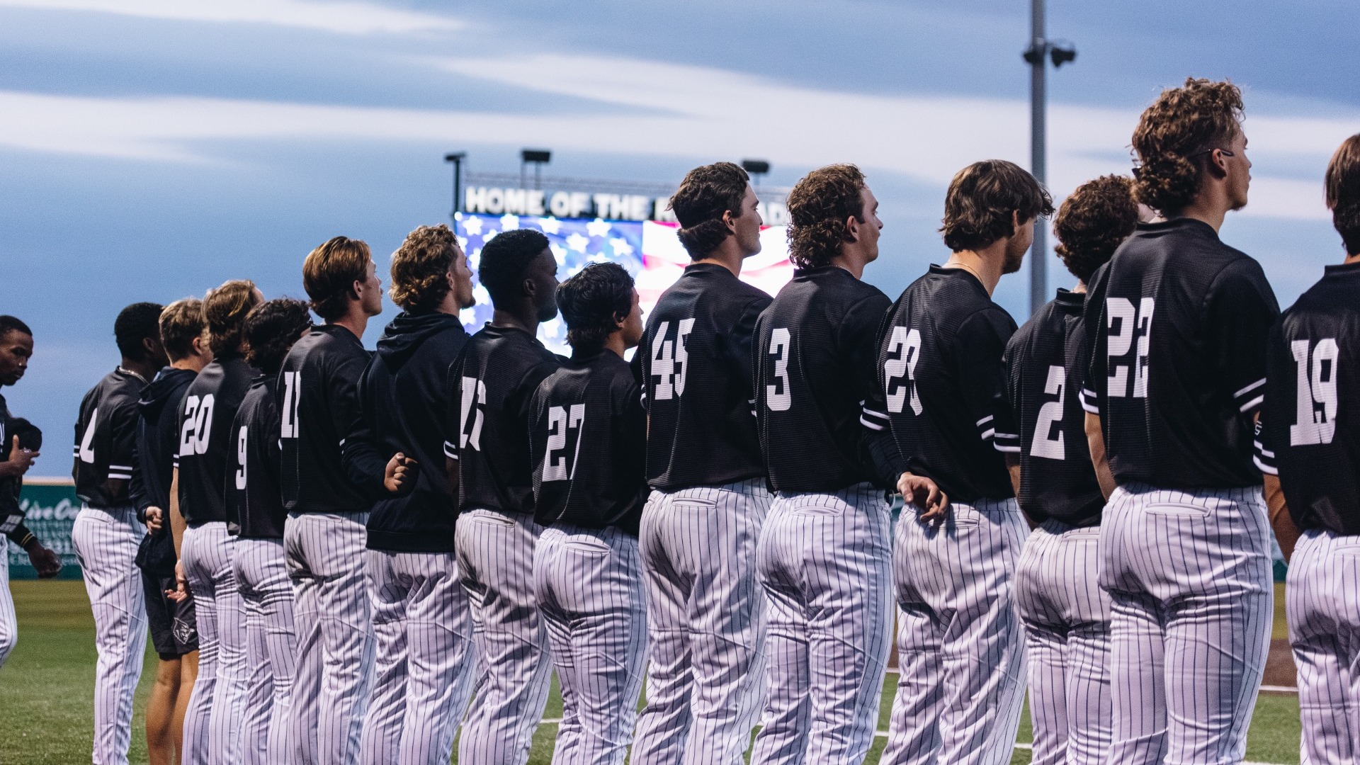 ACU baseball lines up for the National Anthem ahead of its matchup versus Oklahoma State in Cleburne, Texas on Feb. 26, 2025.