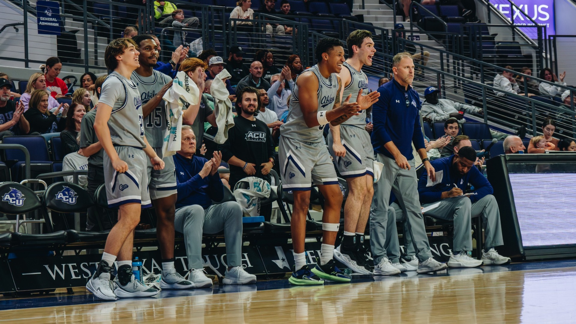 ACU basketball players cheer from the bench against Jarvis Christian on November 28, 2025