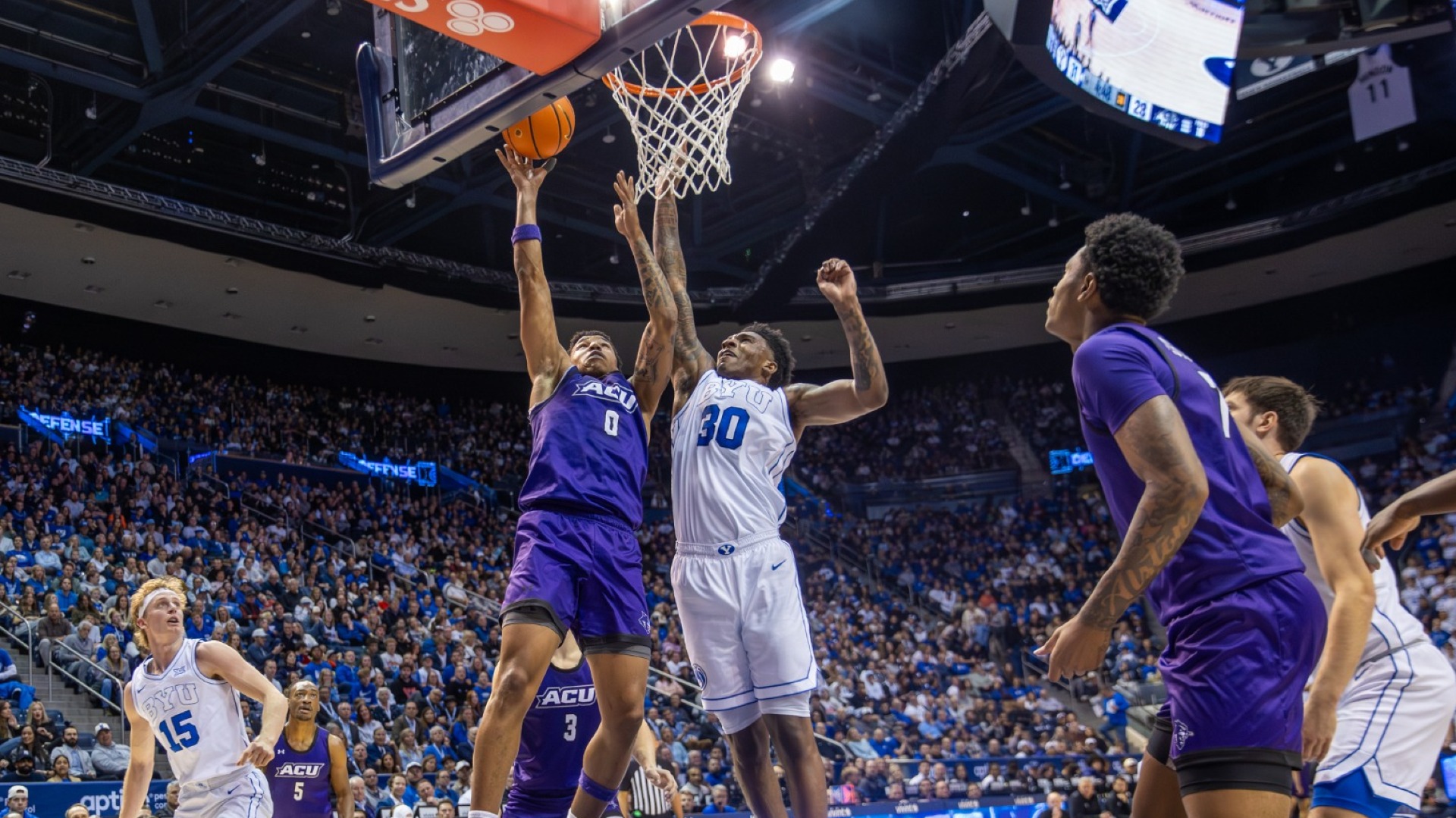 Zy Wright jumps to lay the ball off the backboard against a BYU defense on Dec. 19, 2025