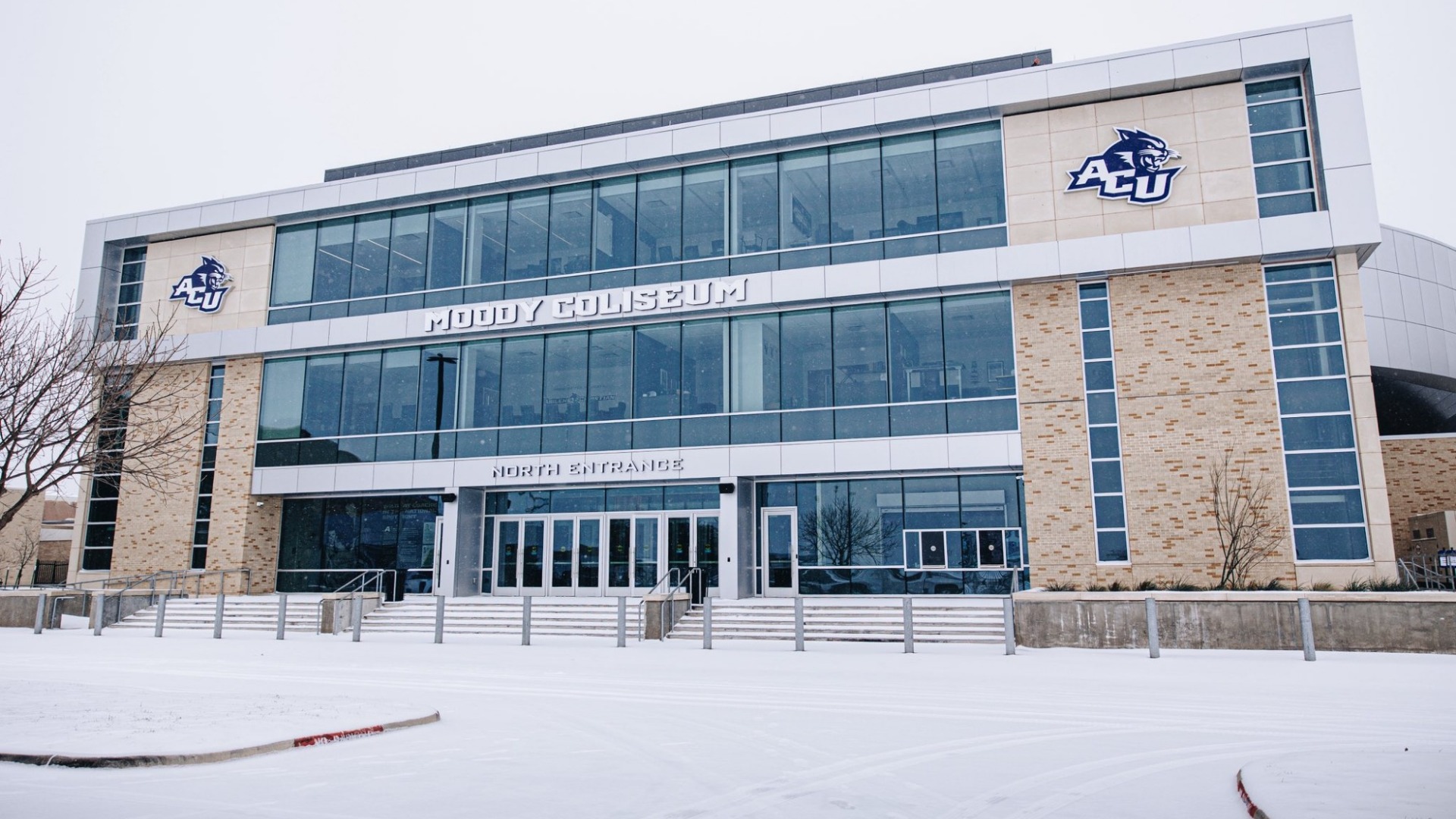 Moody Coliseum during a winter snow and ice storm in January 2026