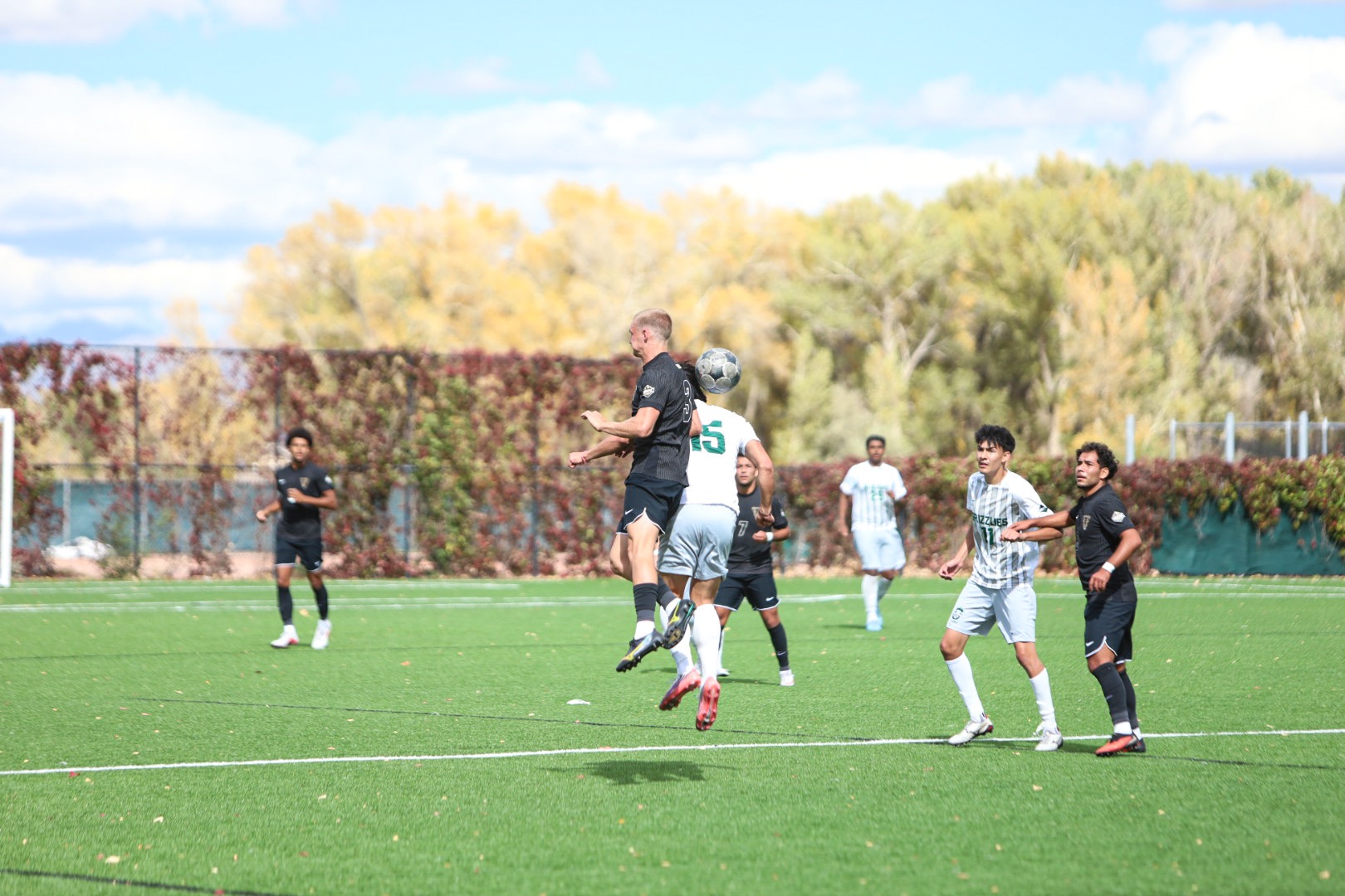 Adams State #15 Andy Pablo jumps up alongside UCCS player #3 for a header in their matchup on October 11,2026