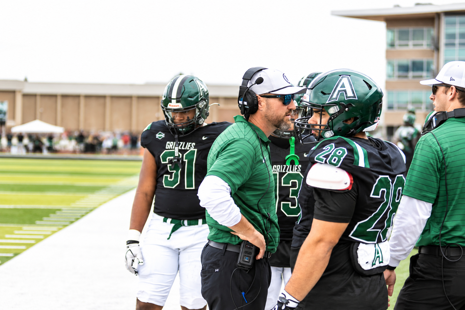Coach Levi Gallas talks to players on the sideline 