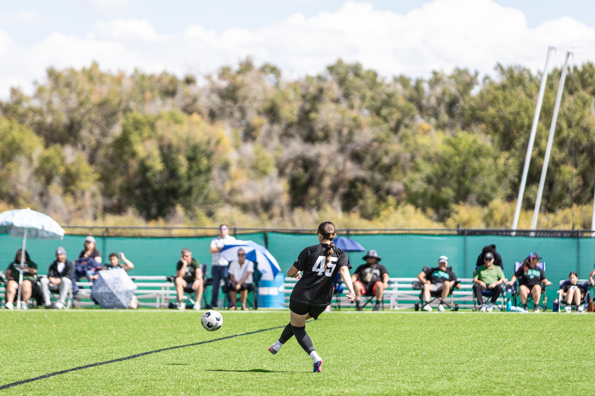 #45 Ashlynn Mustain gears up to take a midfield shot at home soccer match