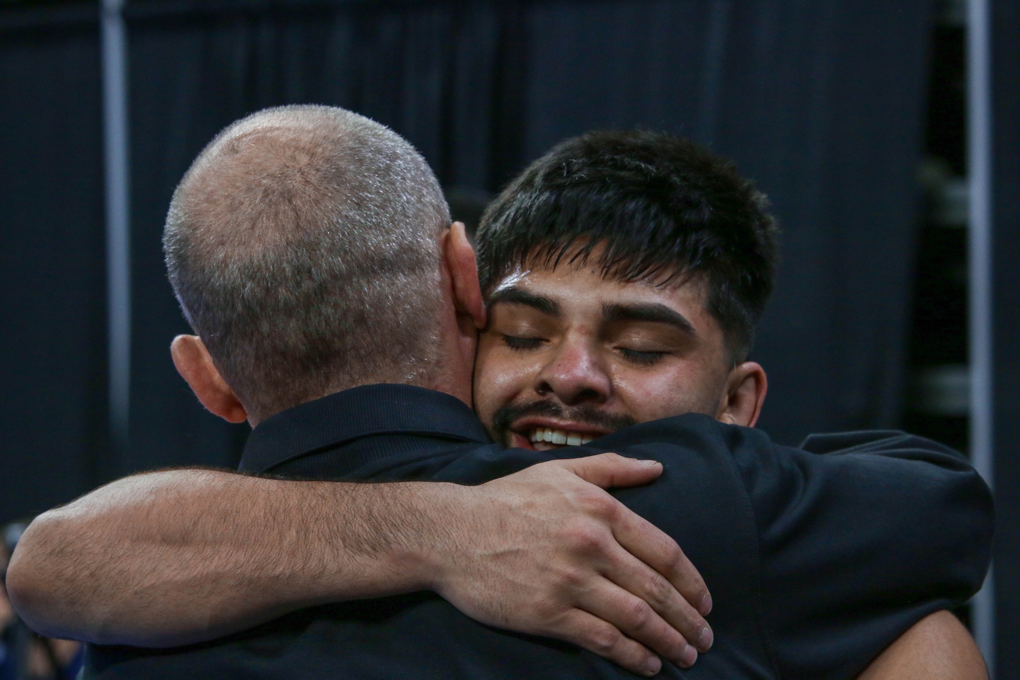 Angel Flores hugging Coach Ram