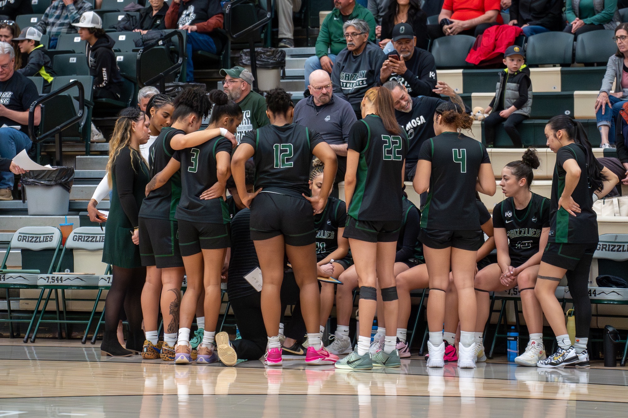WBB RMAC Quarterfinals- Team is in huddle around Coach Mario 