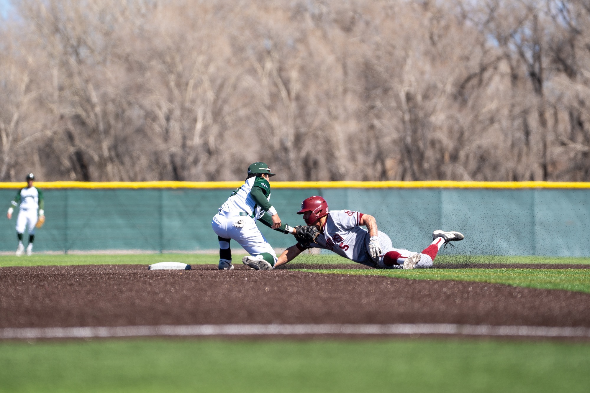 Mac's tagging out a CMU player sliding 