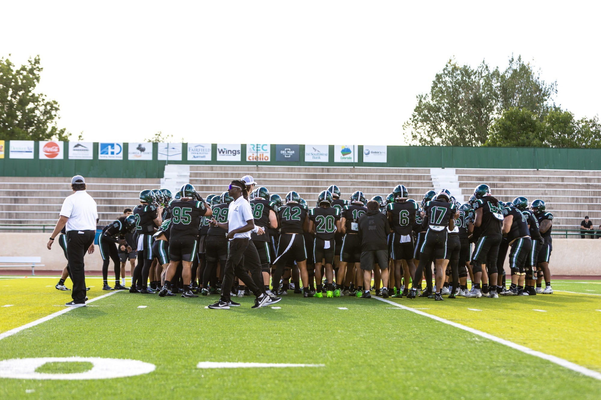 Grizzlies Football Team huddled before the game 