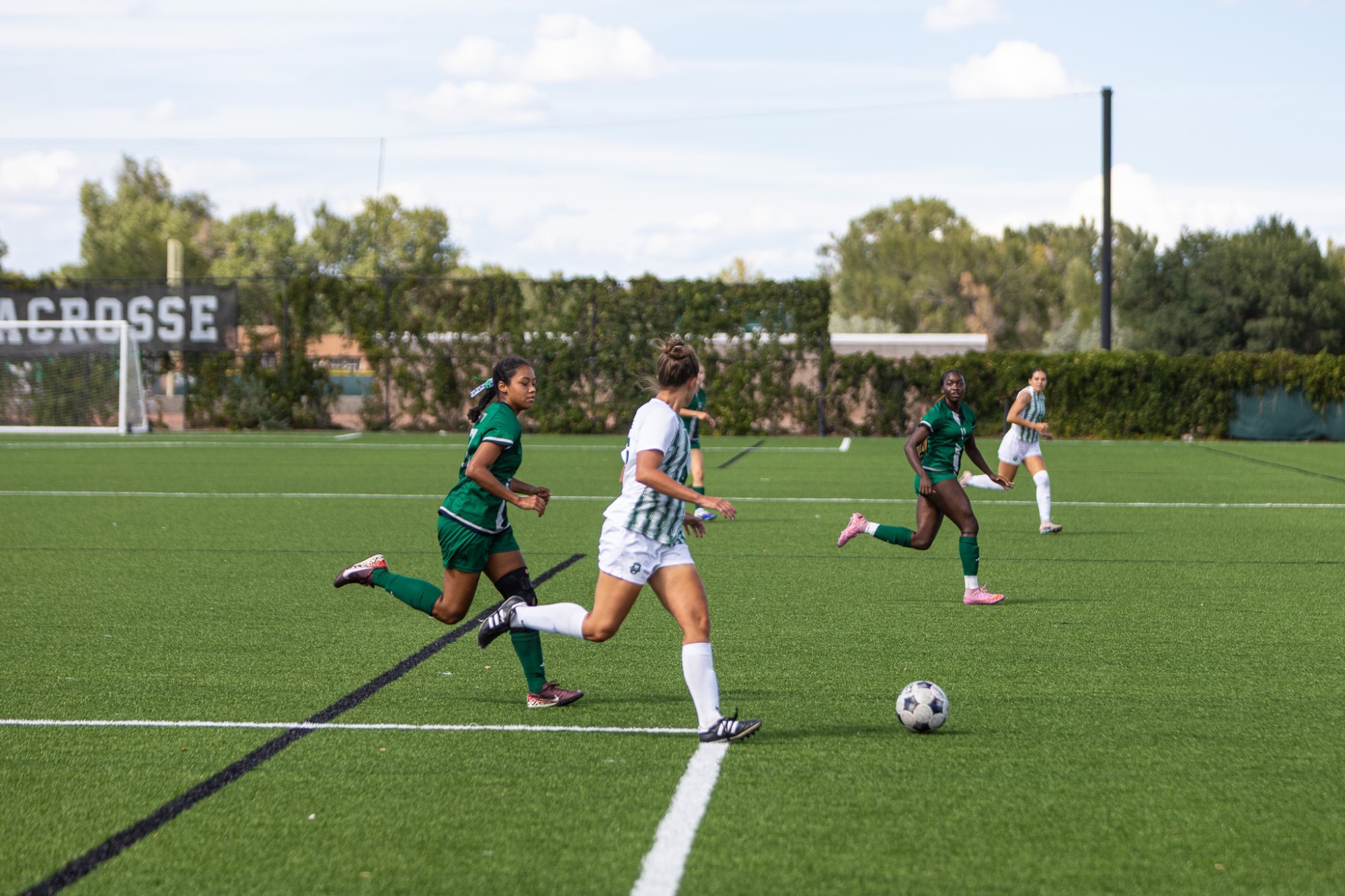 Adams State #46 Chole Fredenbuerg sizes up a kick against 2 Western New Mexico players in their matchup September 5, 2026