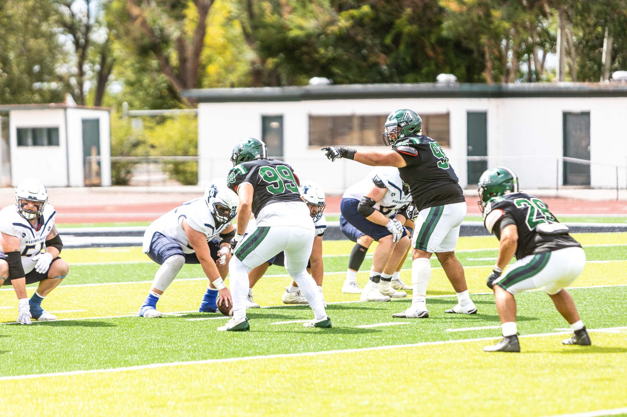 #99 Emil Ventura ,#28 Link Arellenas and #97 Marano-Romero-Garcia line up on defense against SD Mines 