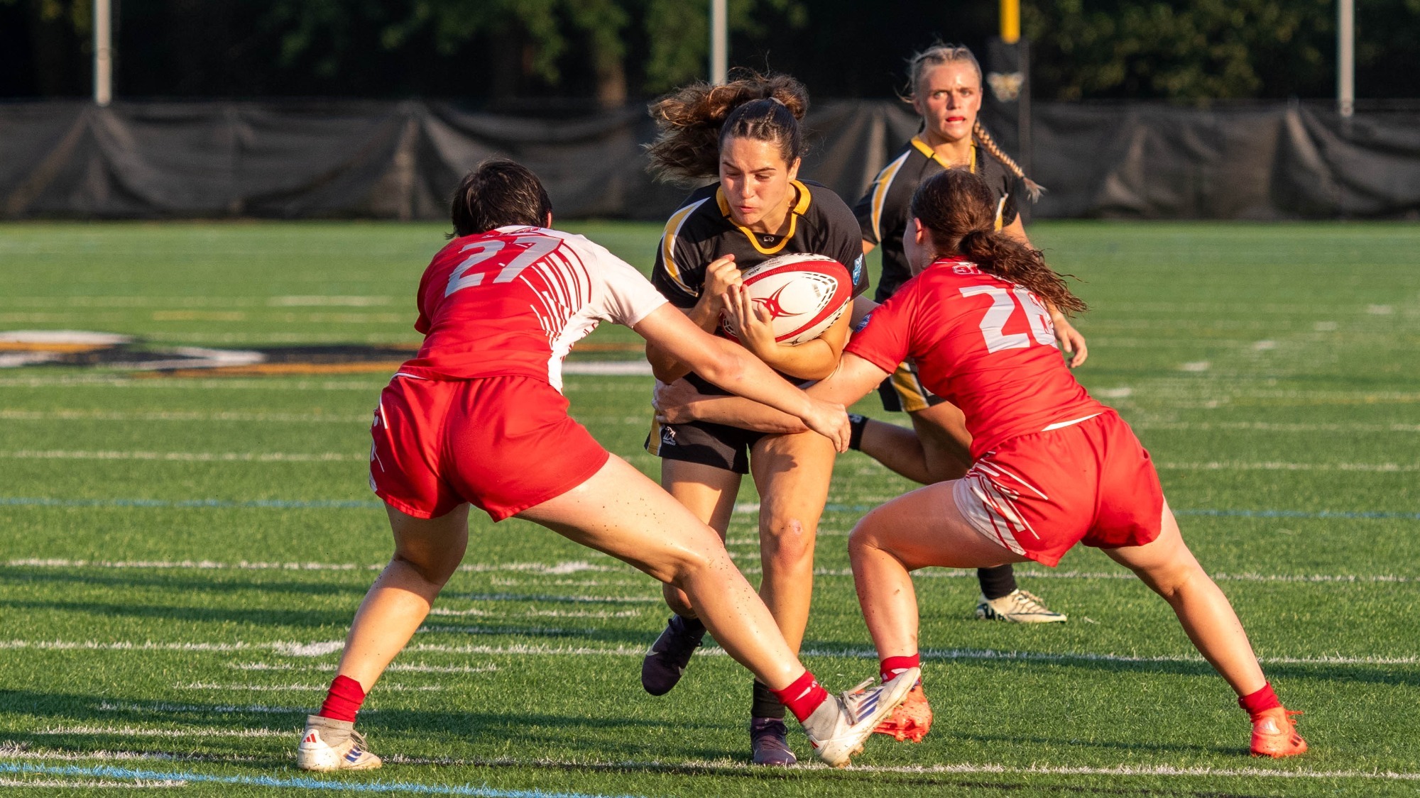 Morgan Schechter runs through two Sacred Heart Defenders