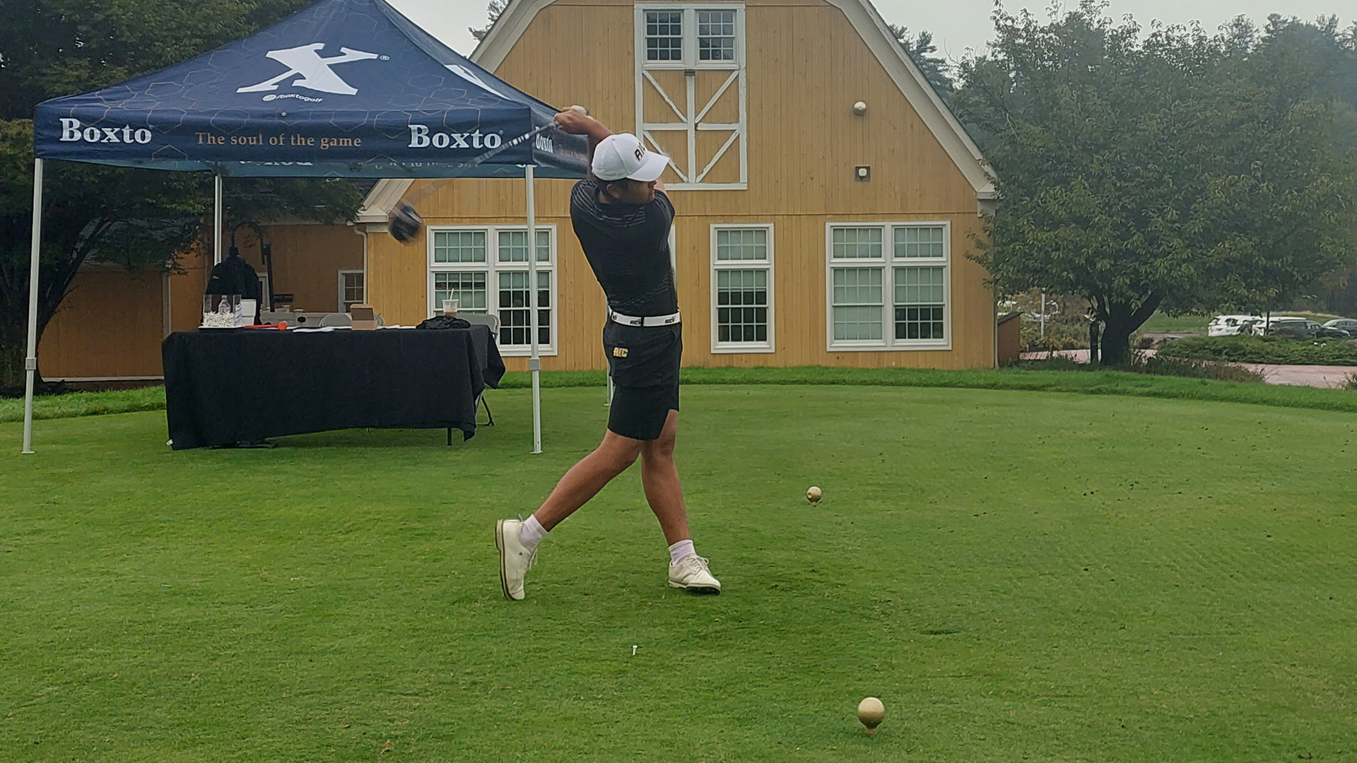 An AIC Golfer tees off at the AIC Invitational