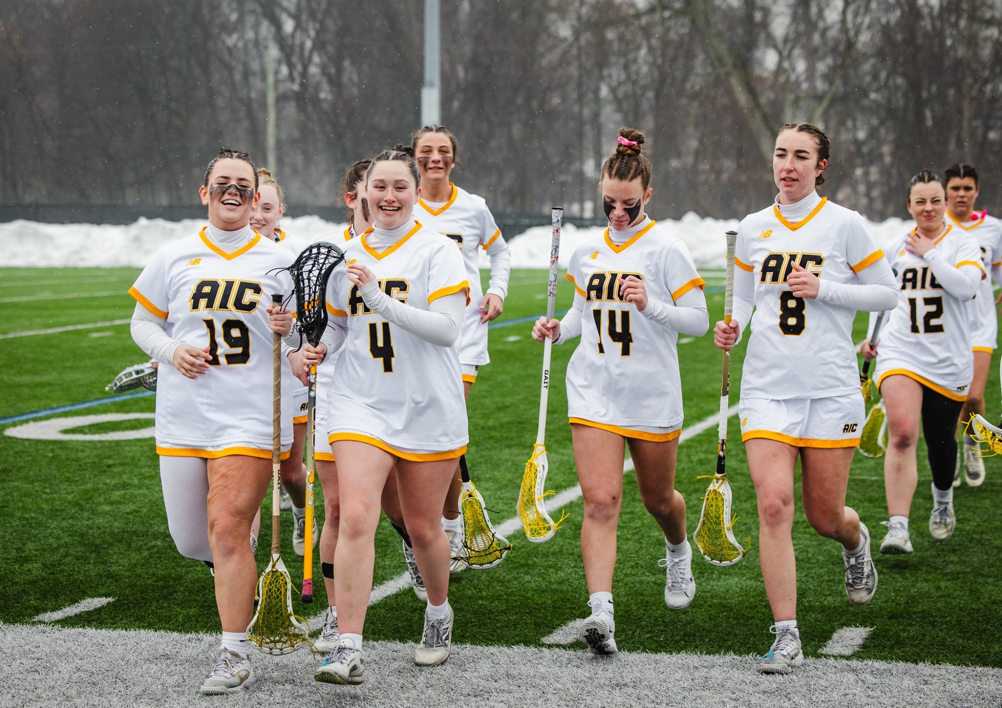 The 2026 women's lacrosse team runs toward the sideline