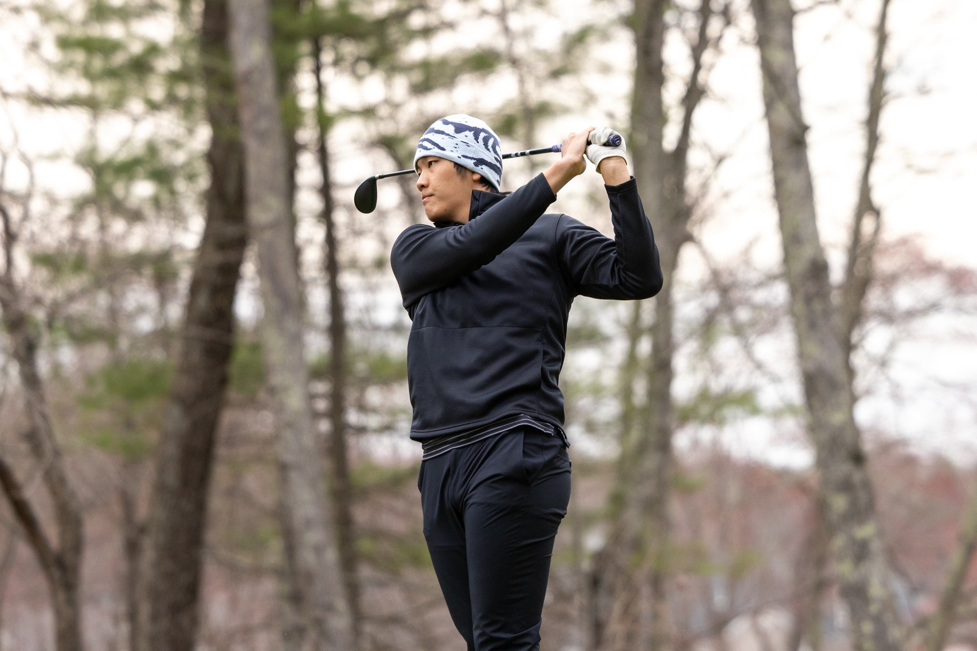 Tommy Huang looks at a shot