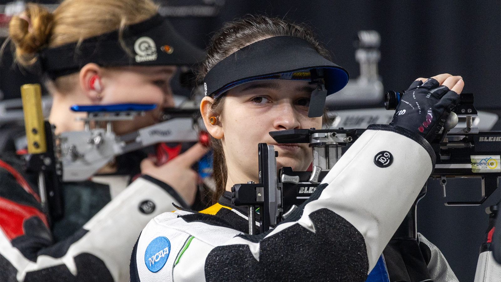 Lucie Kissenberger shooting at NCAA Championships, looking to her coaches from the point at Kentucky