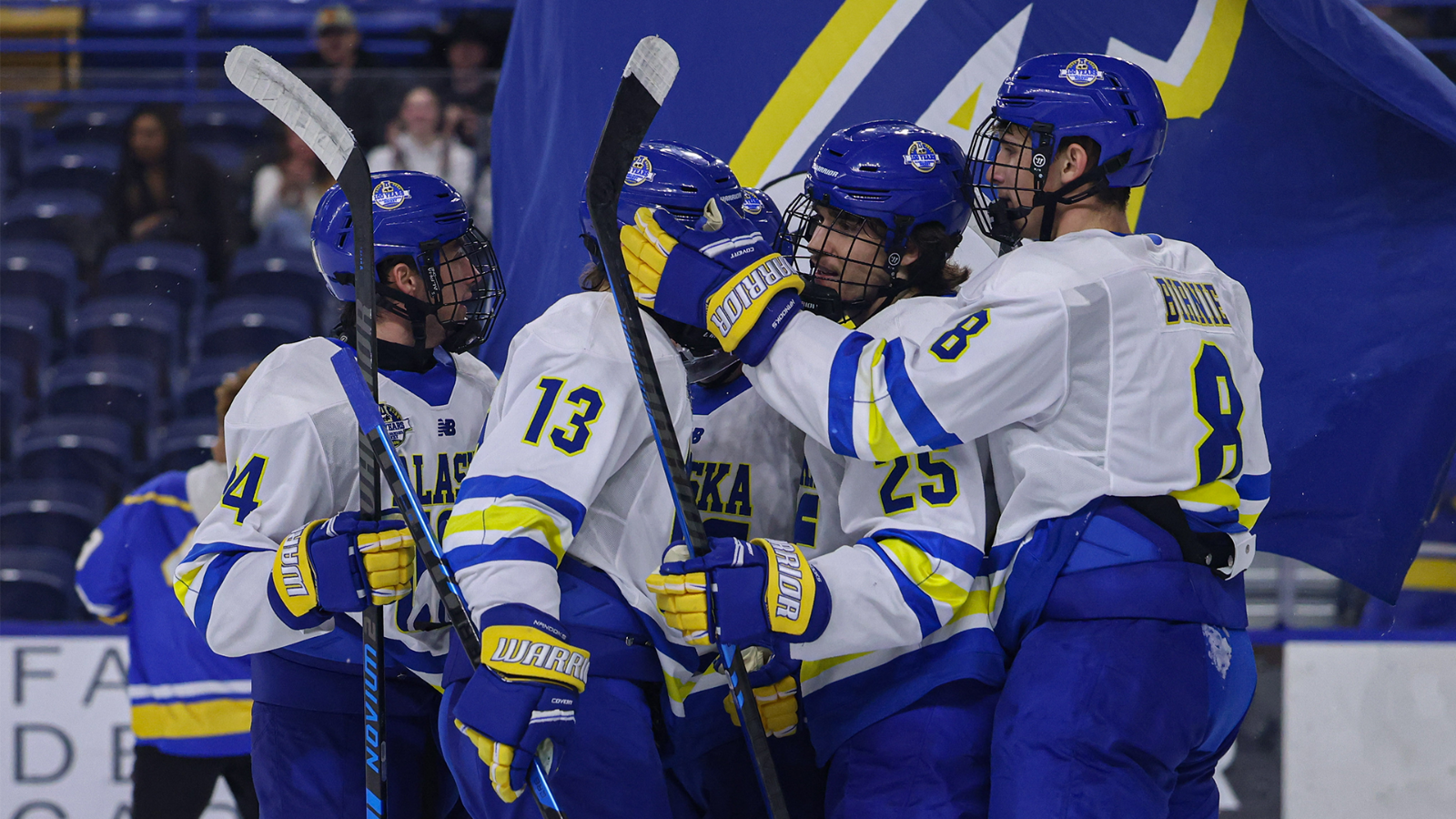 The Nanooks celebrate on the ice as the A-Bear flag goes by in the background
