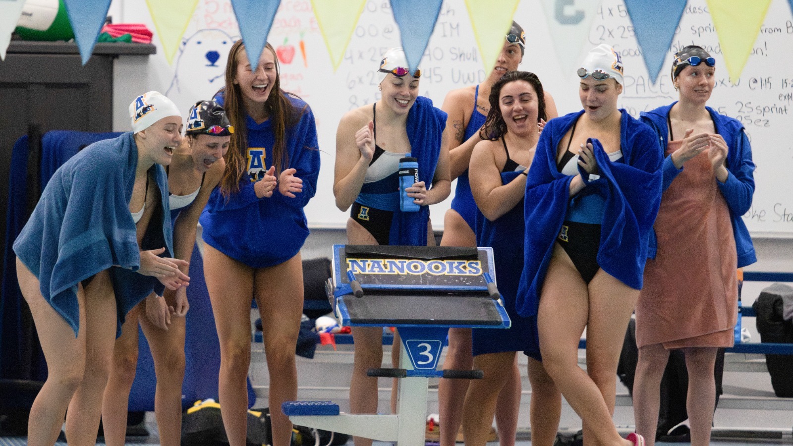 The Nanooks cheer on their teammates at the Blue/Gold meet, 2025-26