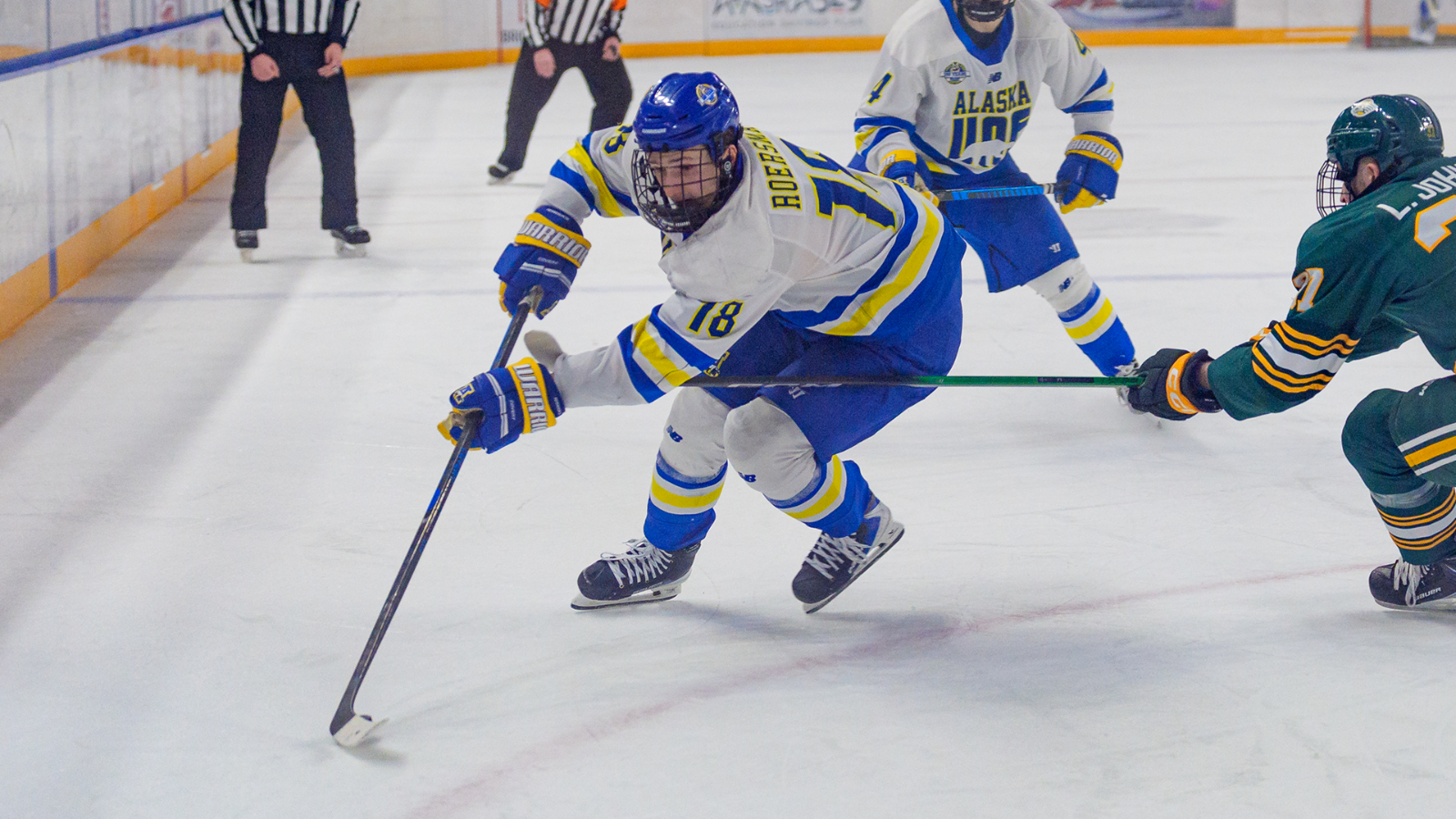 Rylen Roersma skates through contact against UAA