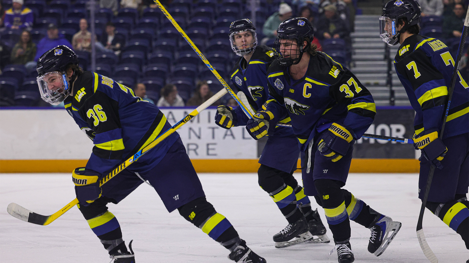 Davis Borozinskis (L) and Chase Dafoe (R) skate towards the bench to celebrate a goal against LIU (1/30/26)