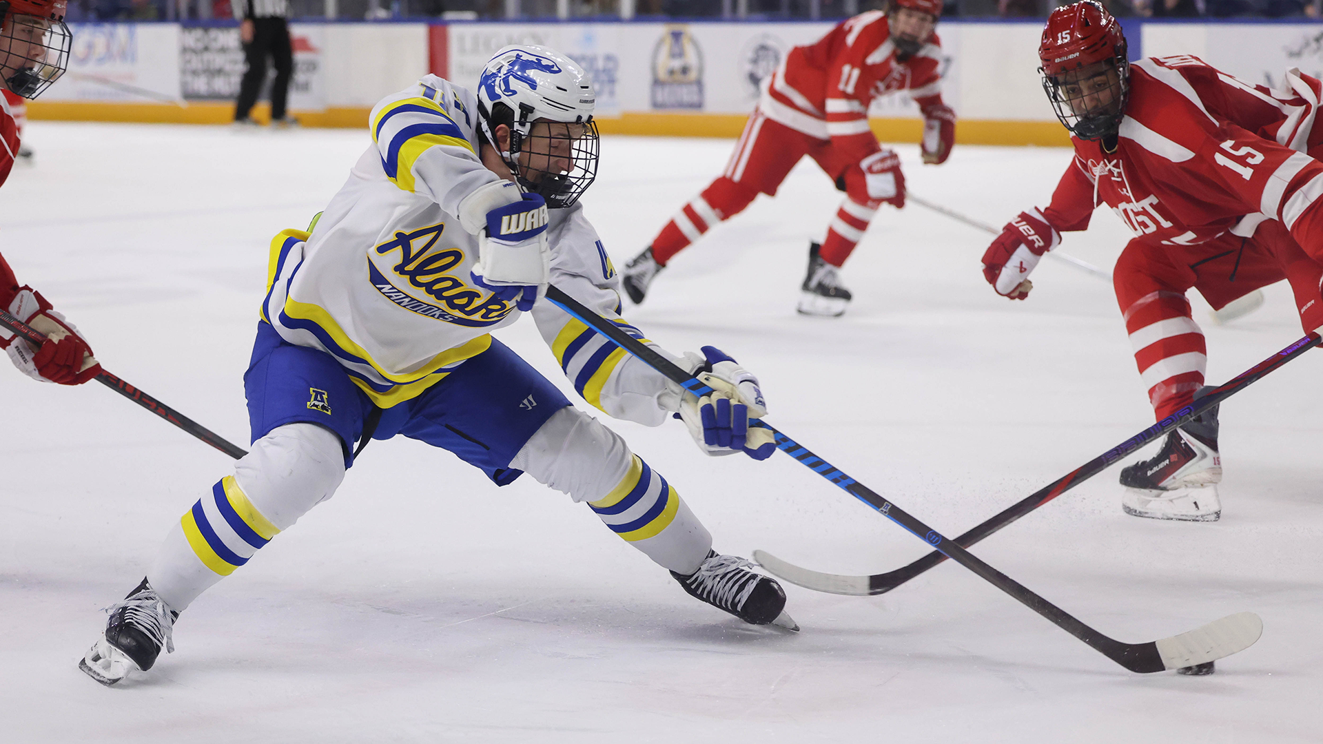 Rylen Roersma plays the puck through Boston defenders near the attacking zone