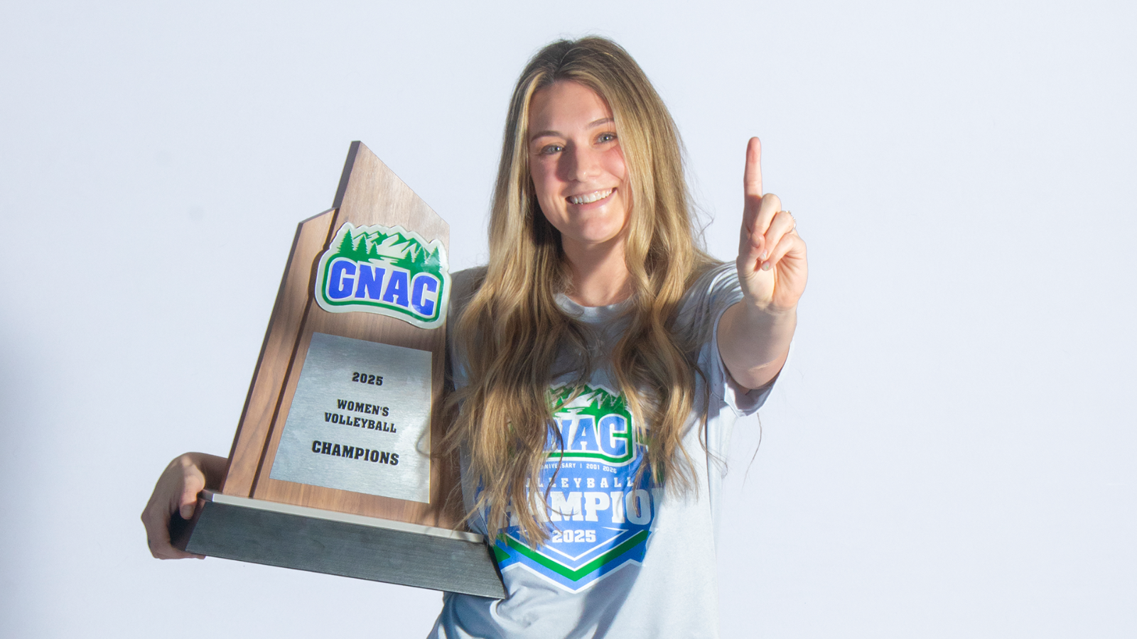 Meagan Woods poses with the 2025 GNAC Volleyball Championship Trophy