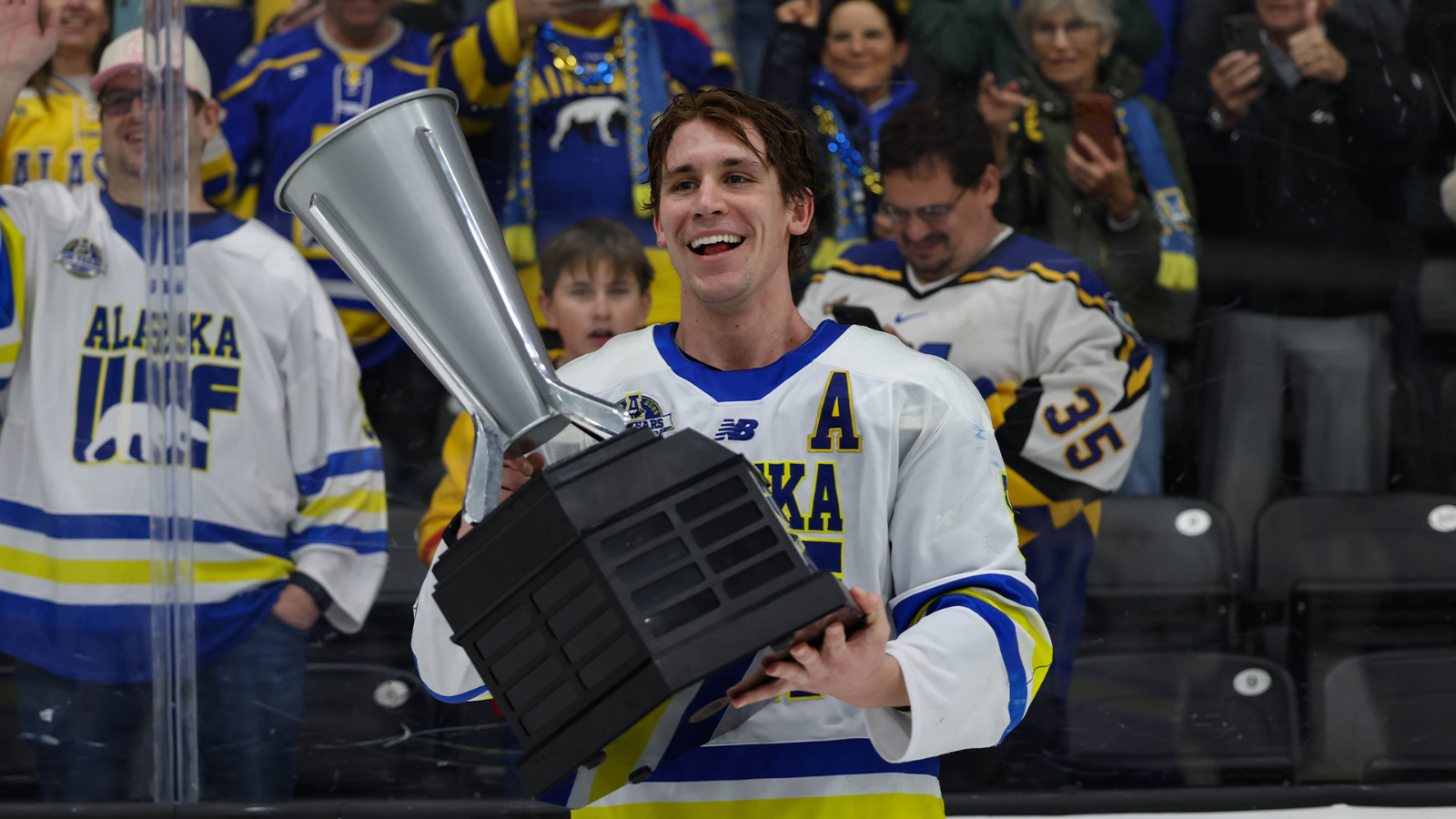 Braden Birnie lifts the UCHC Cup after the Nanooks' inaugural championship