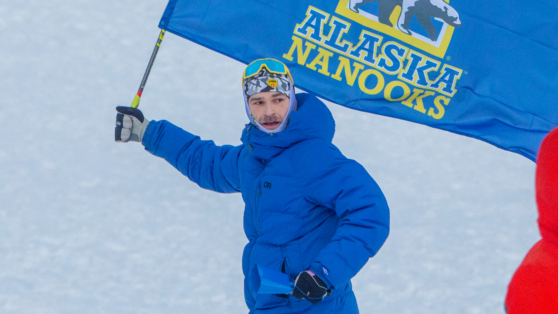 Ben Buck running with flag at home UAF ski race