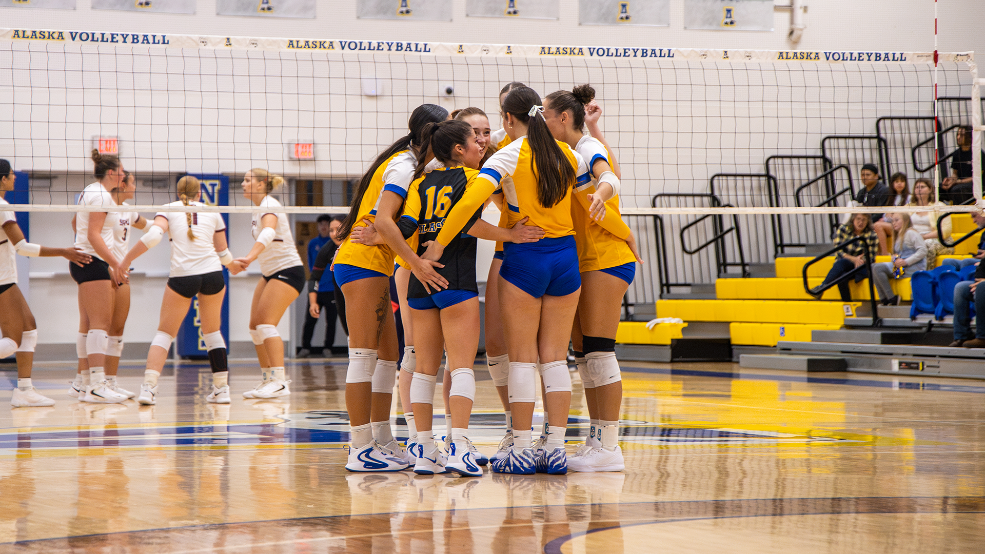 Volleyball huddles after a point against Seattle Pacific