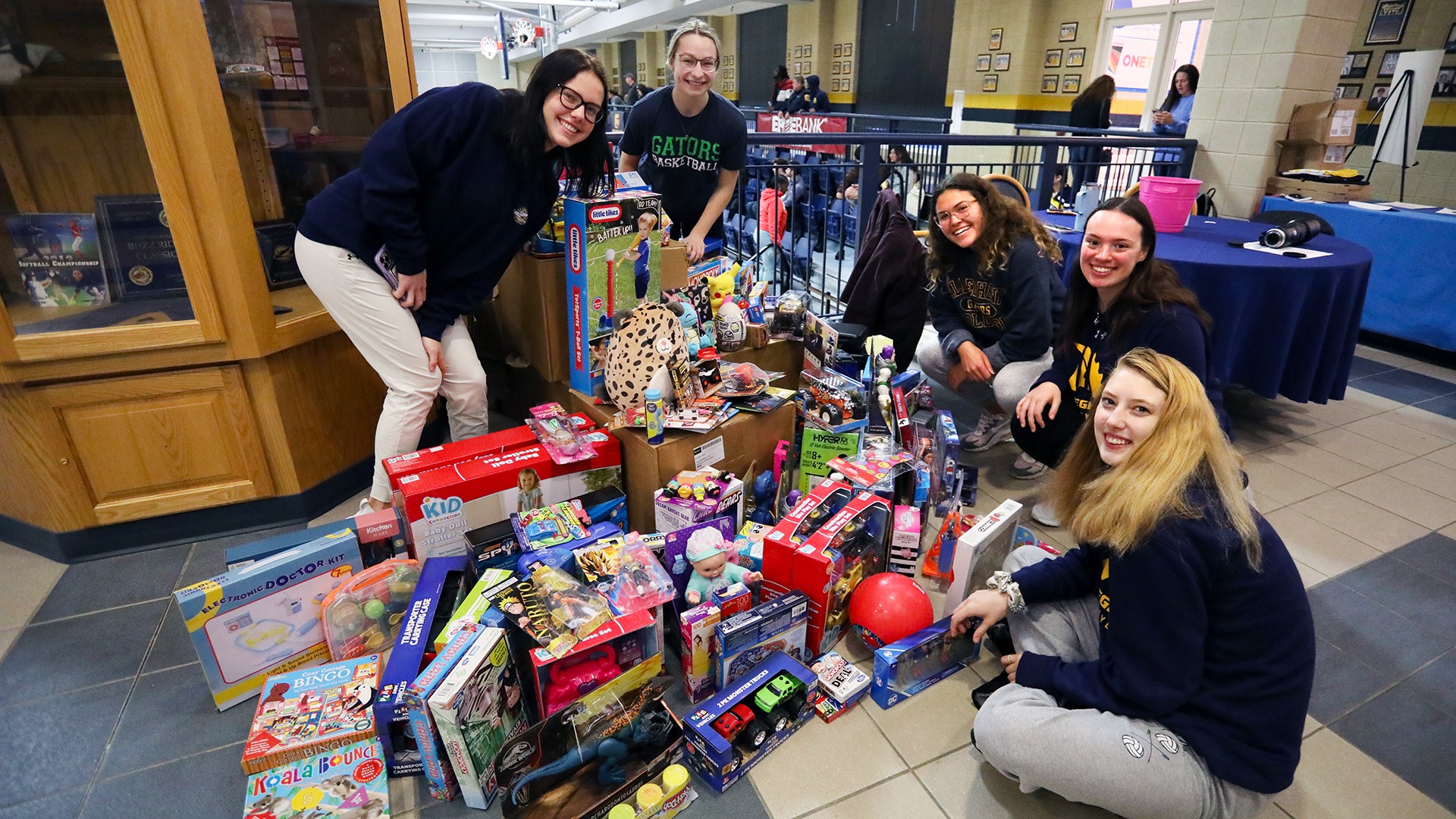 Allegheny students with the toys collected during the basketball toy drive on December 2, 2022, against Thiel. Photo by Ed Mailliard.