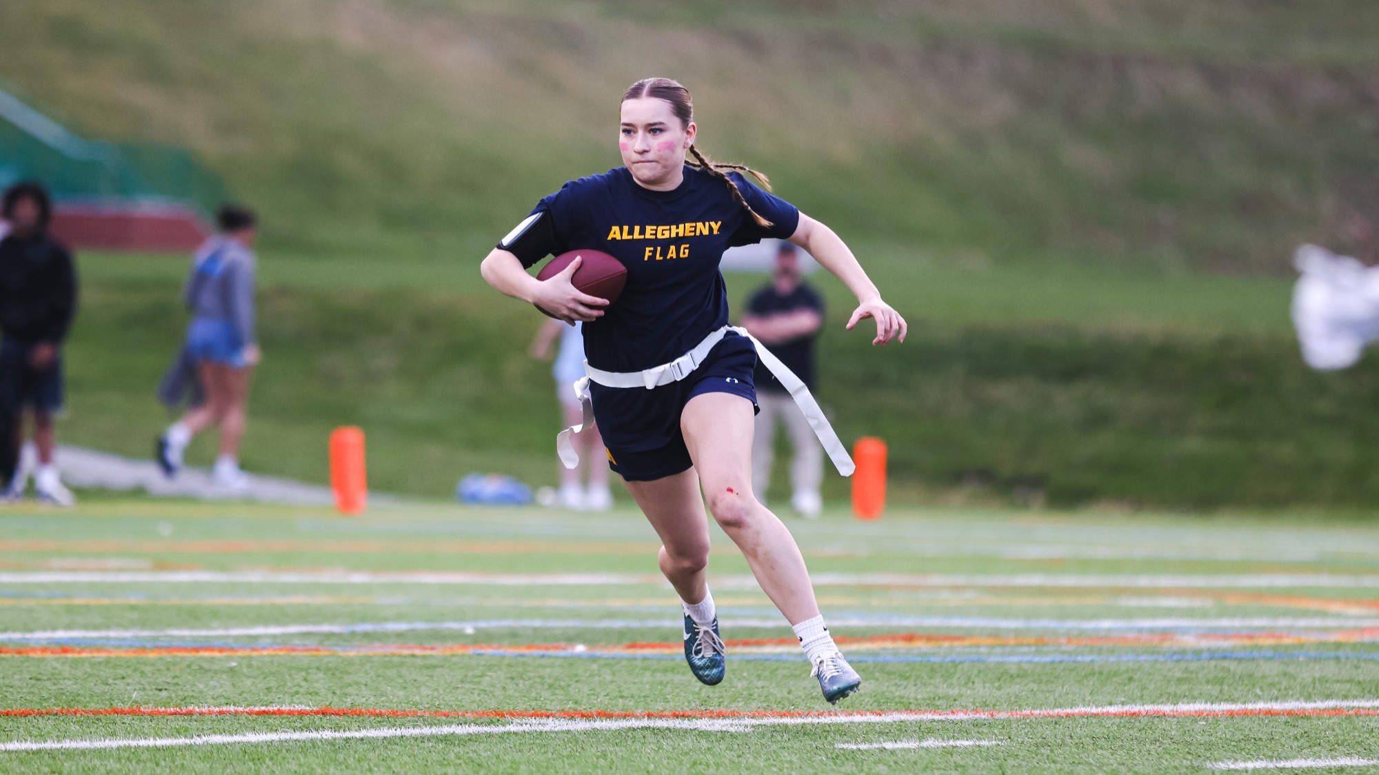 Madeline Schneider runs with the ball in a flag football showcase game at Saint Vincent, March 29, 2025. Photo by Alex Mowrey/Pittsburgh Steelers.