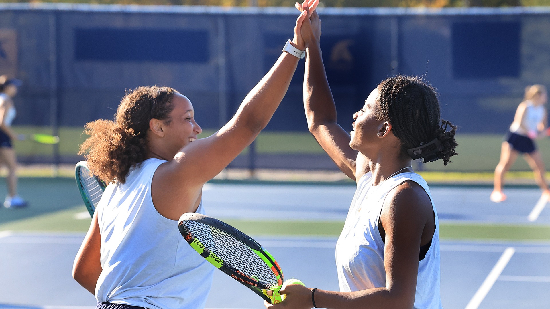 Claire Terefe (L), Gabrielle Bassette (R) celebrate vs. Franciscan, Oct. 22, 2026. Photo by Ed Mailliard.