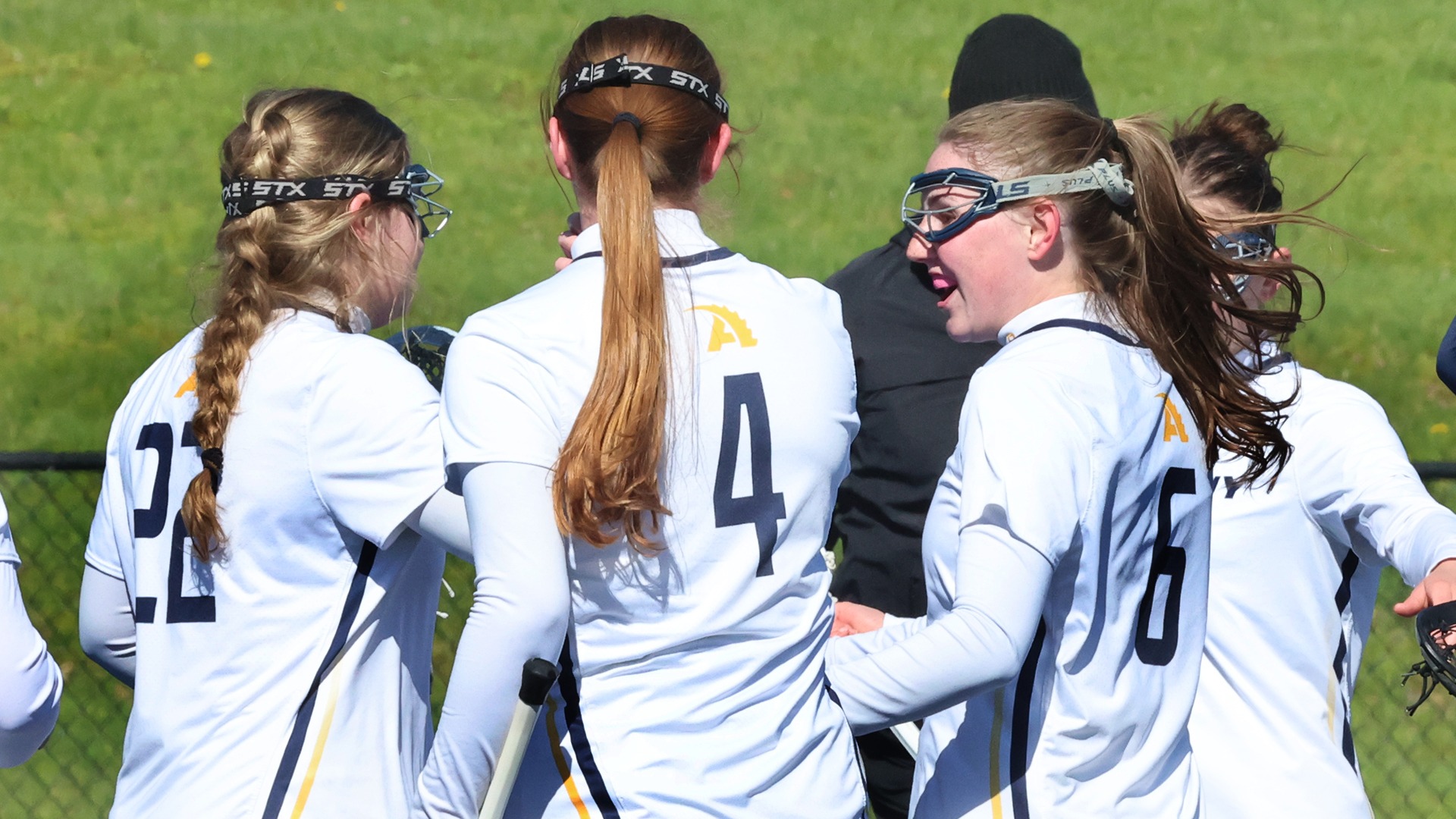 Women's Lacrosse celebrates a goal against Thiel