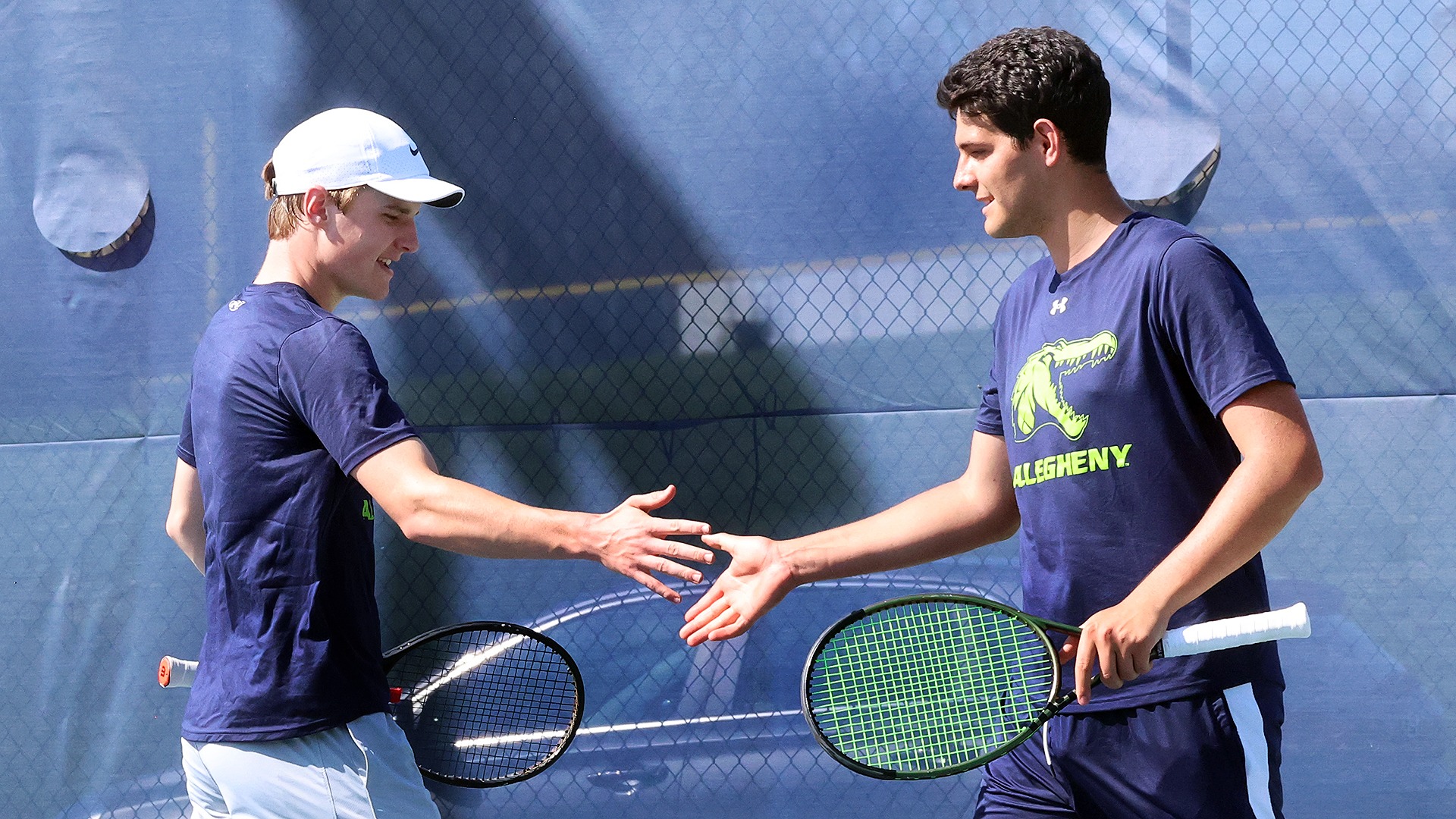 Olivier Erkens (L) and Levente Mihaly (R) high five during doubles match vs. W&J, April 23, 2026. Photo by Ed Mailliard.