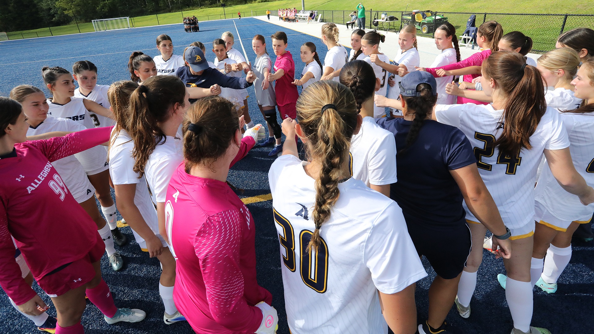 Women's soccer huddles before a game