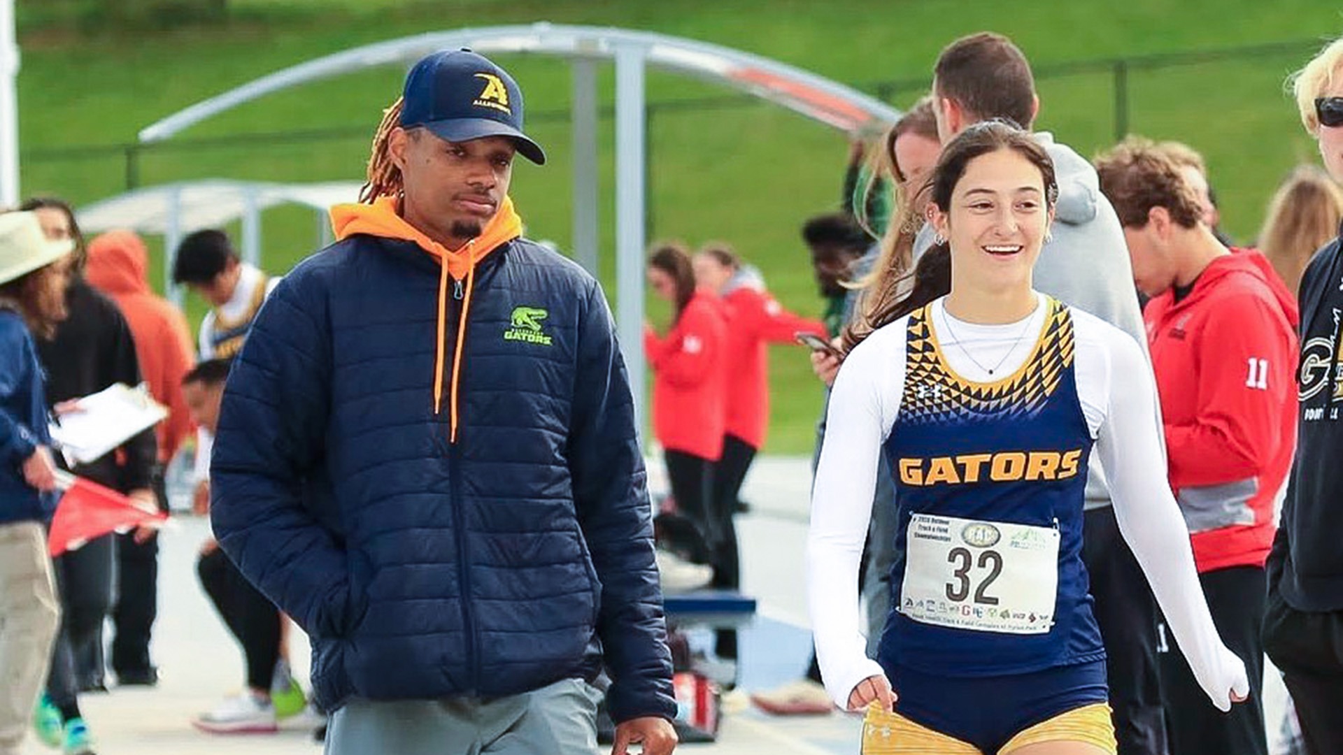 Assistant track & field/xc coach JB Blackmore (L) and Aubryanna Snyder (R)