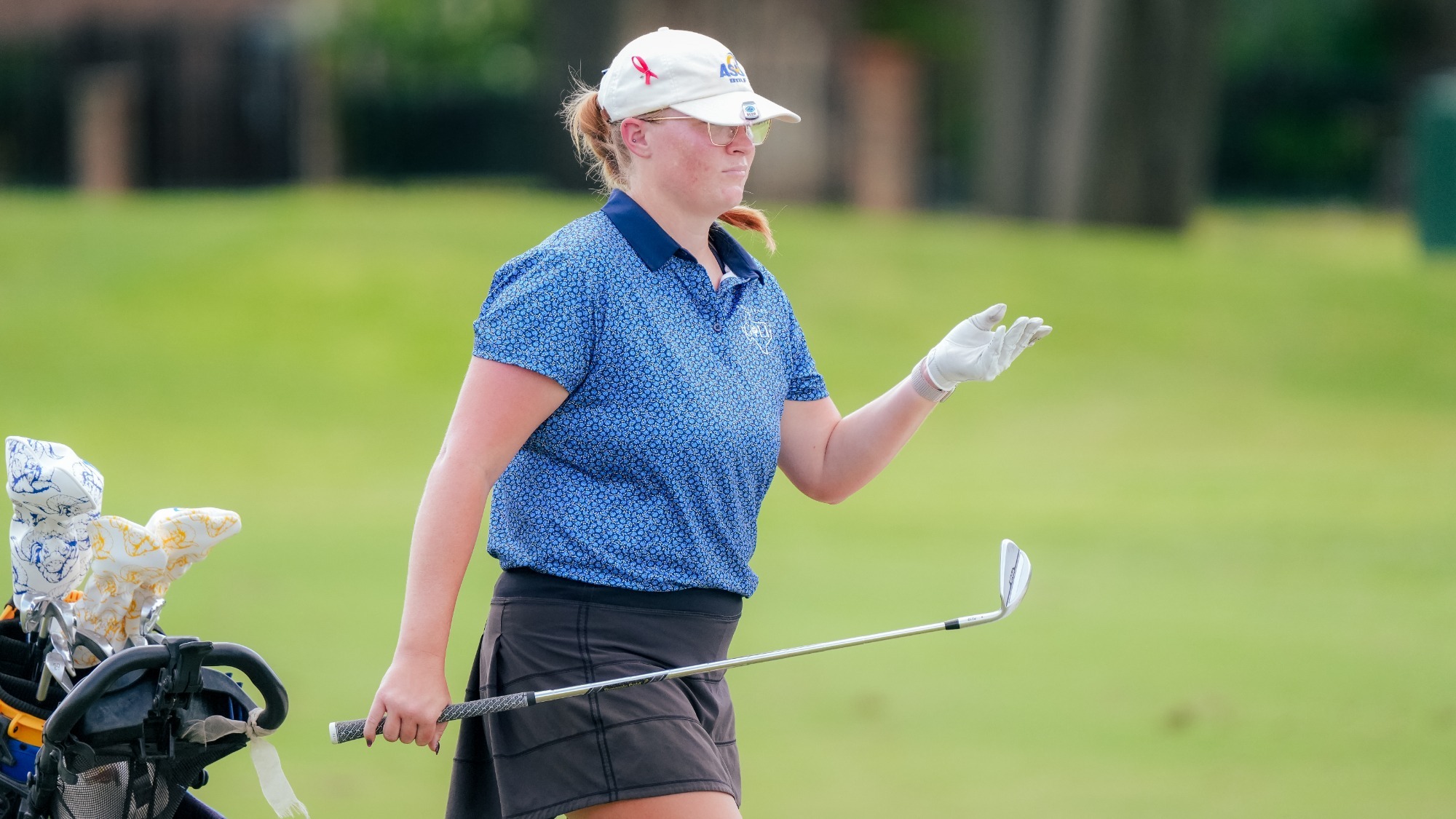 Kelsey Kline holding onto her iron as she points forward