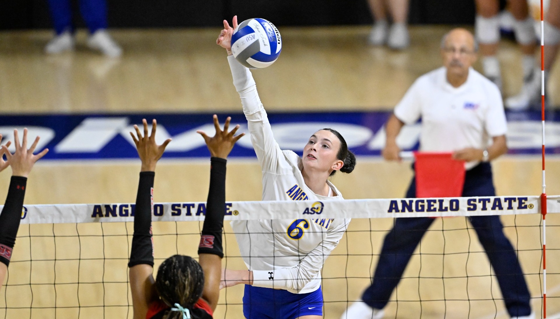 Madi Parrish swinging at the net