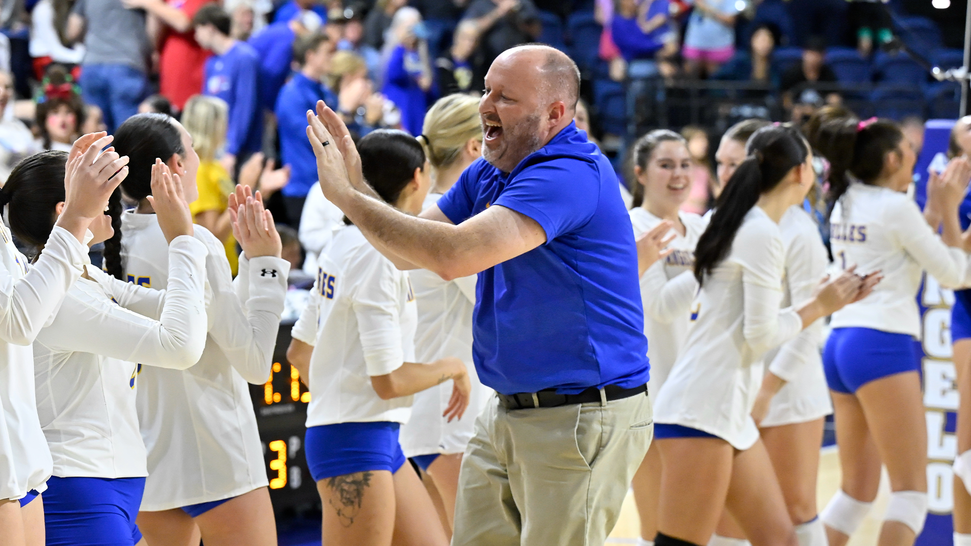 Head coach Chuck Waddington going down the celebration line