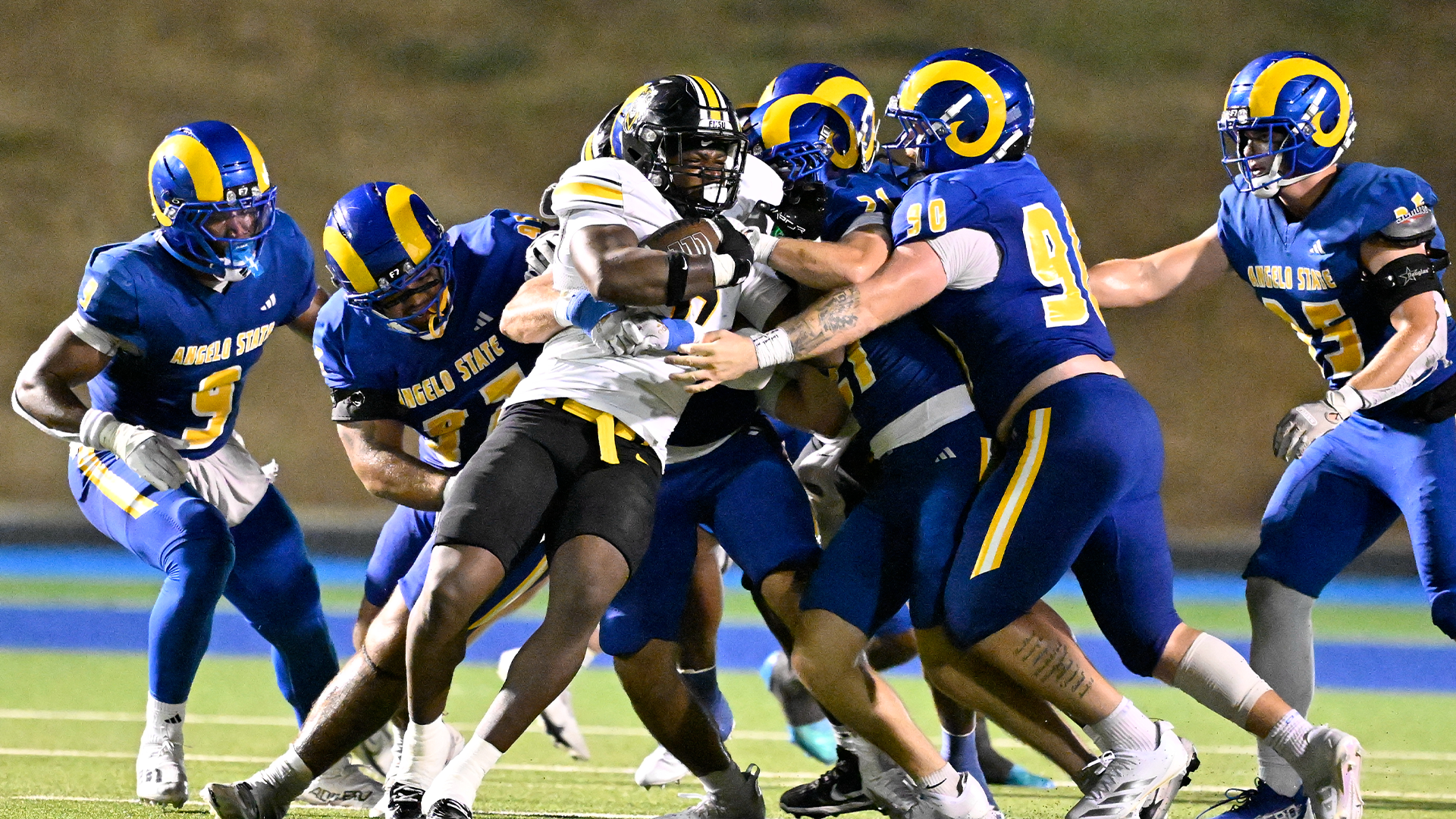 Rams defense tackling a running back