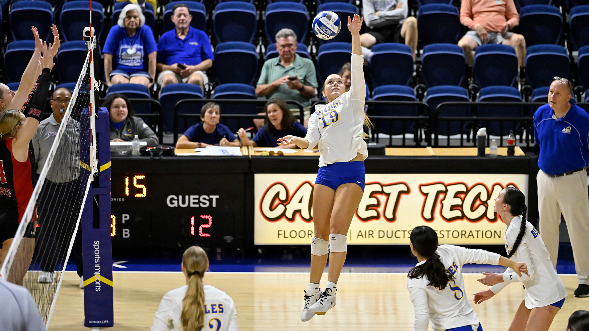 Leah Klueber swinging at a volleyball