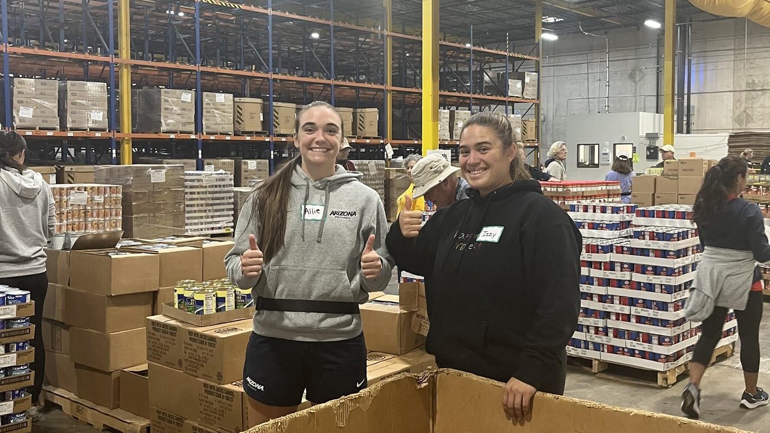 Allie Skaggs and Izzy Pacho volunteering at Community Food Bank