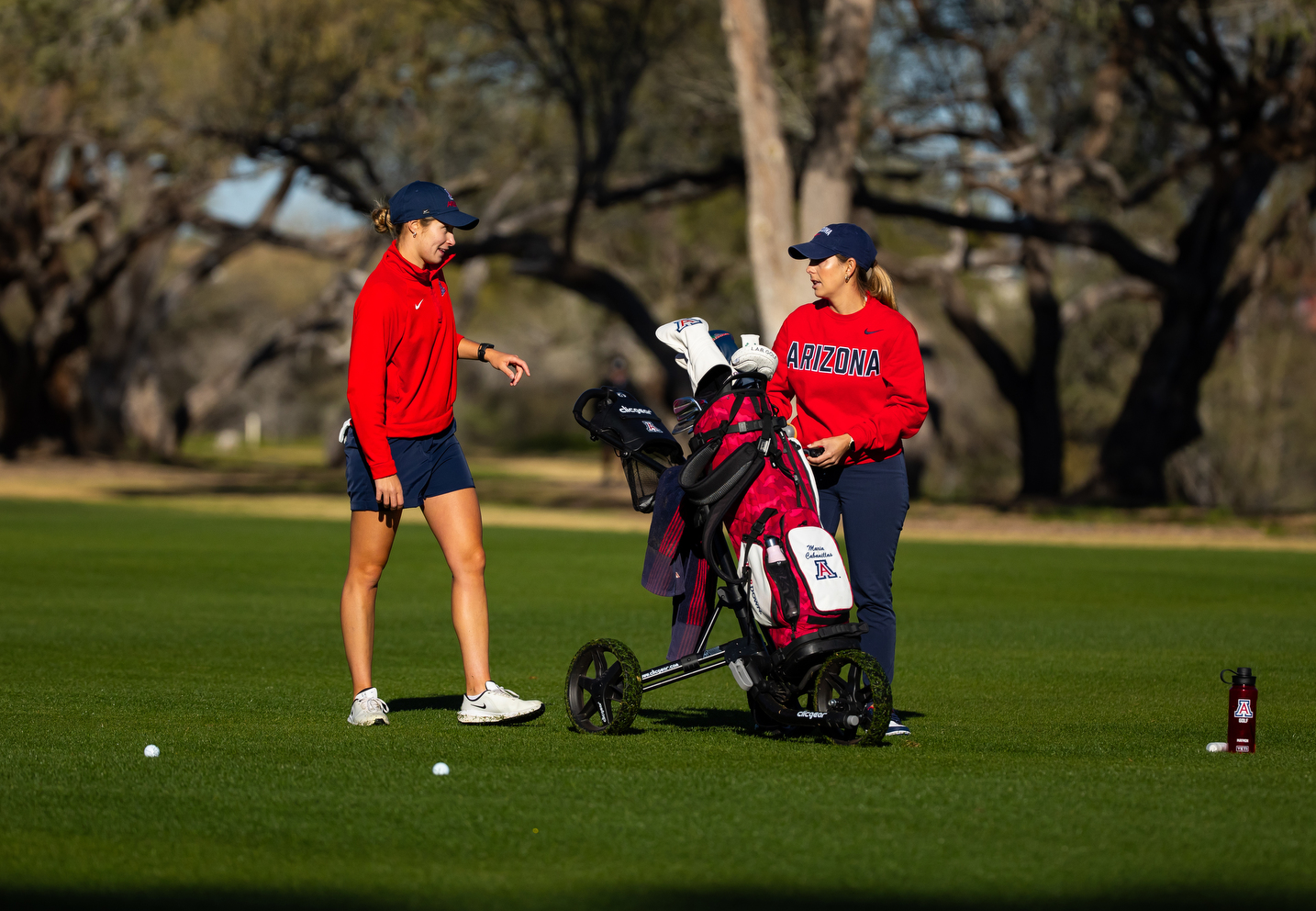 Maria Cabanillas, Giovana Maymon, head coach — TUCSON, ARIZ. -- Women’s golf competes in the first day of the 2026 Thunderbird Intercollegiate at Tucson Country Club.Feb. 9, 2026. Photo by Mike Christy / Arizona Athletics