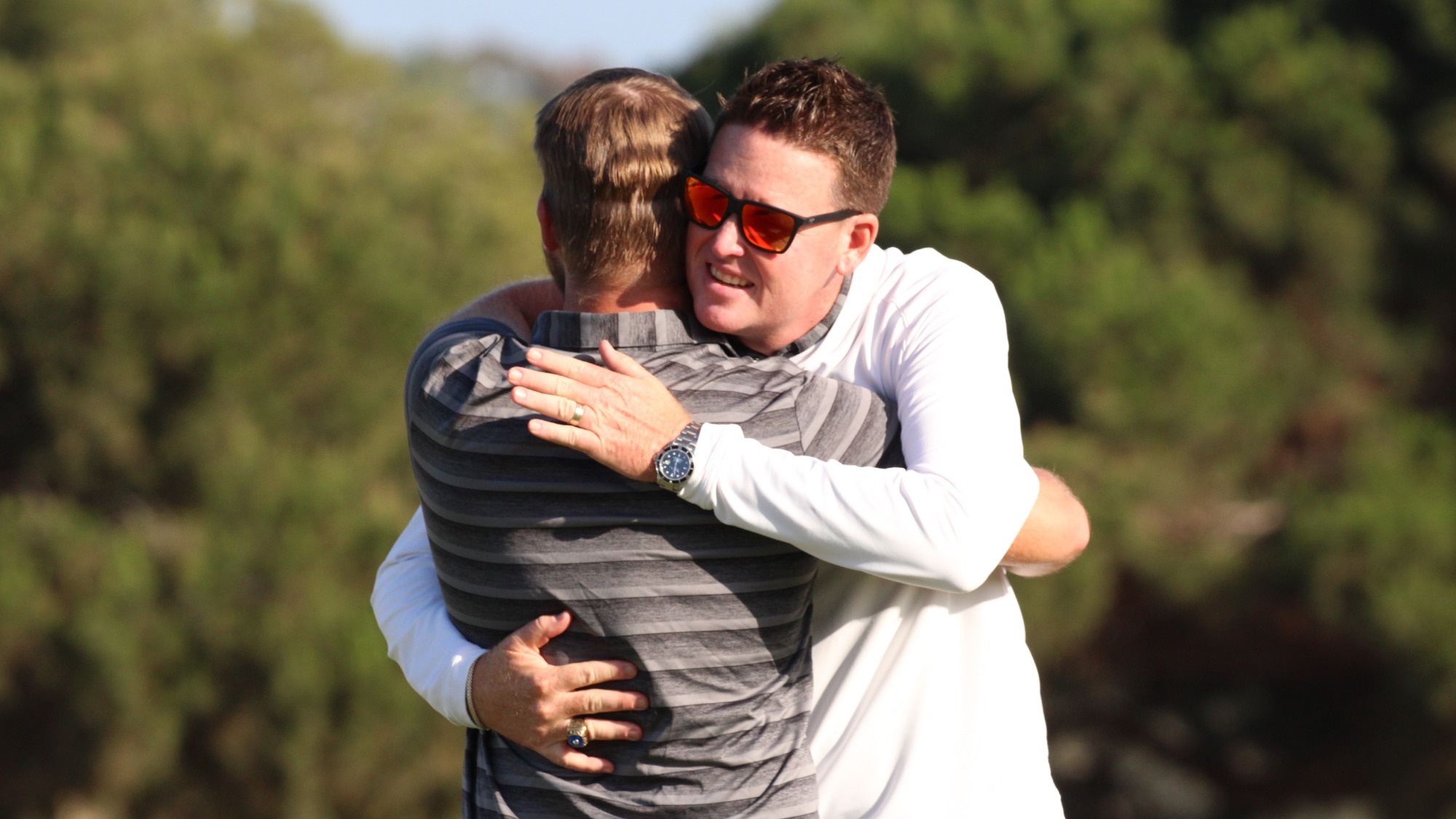 Head Coach Mike Hagen and senior Thomas Schmidt embrace at the conclusion of the NCAA Championships at Omni La Costa Resort & Spa