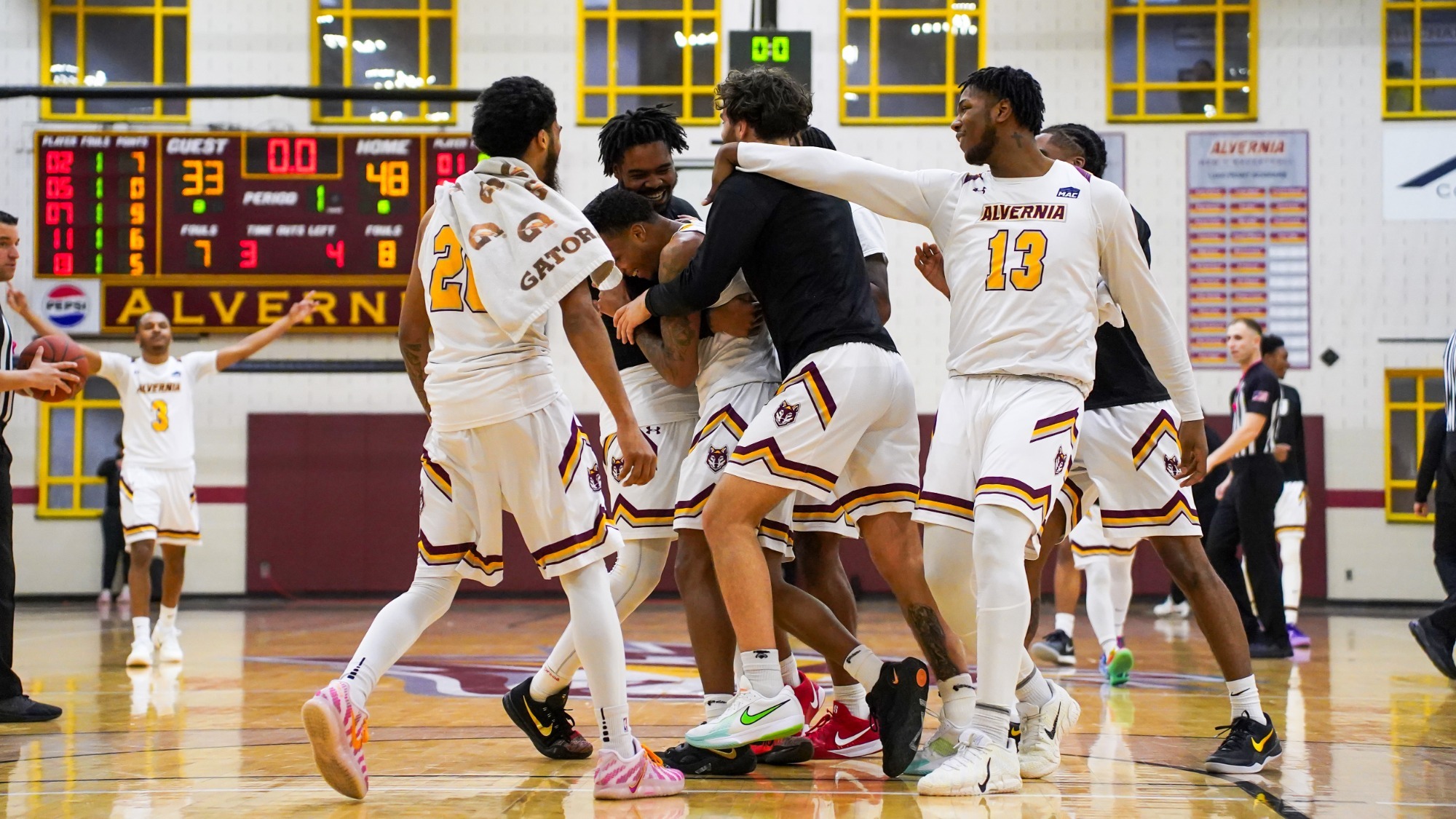 Alvernia men's basketball celebrates after a halftime buzzer beater is converted by Janye Stanley