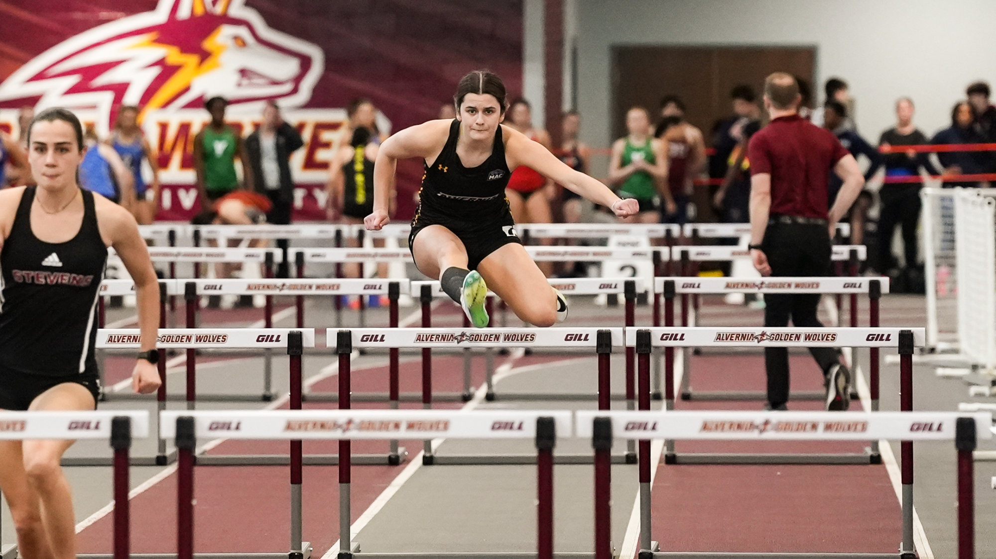 Brooke Hall jumping over a hurdle