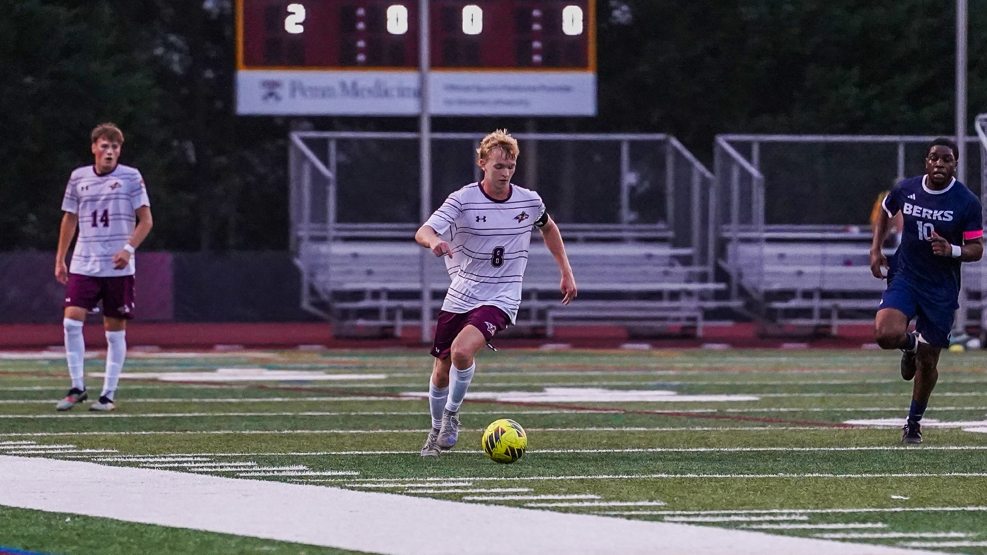 Jackson Taliani dribbles the ball toward a defender