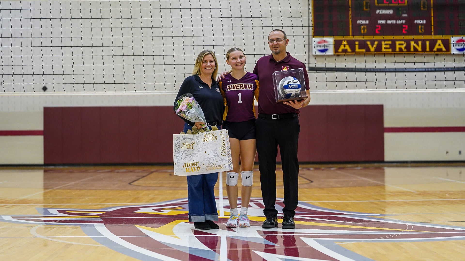 Olivia Rohrbaugh with her parents on senior night