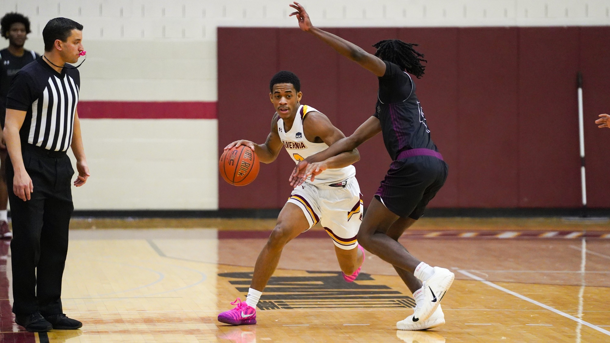 Saleem Hudson dribbles by his defender