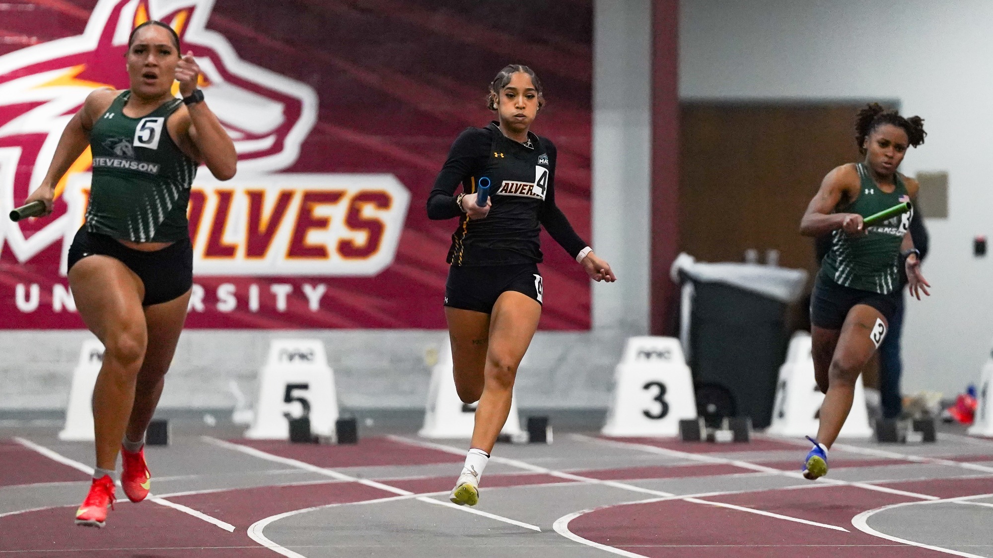 Giavanni Gibson runs through her leg of the 4 by 200 meter