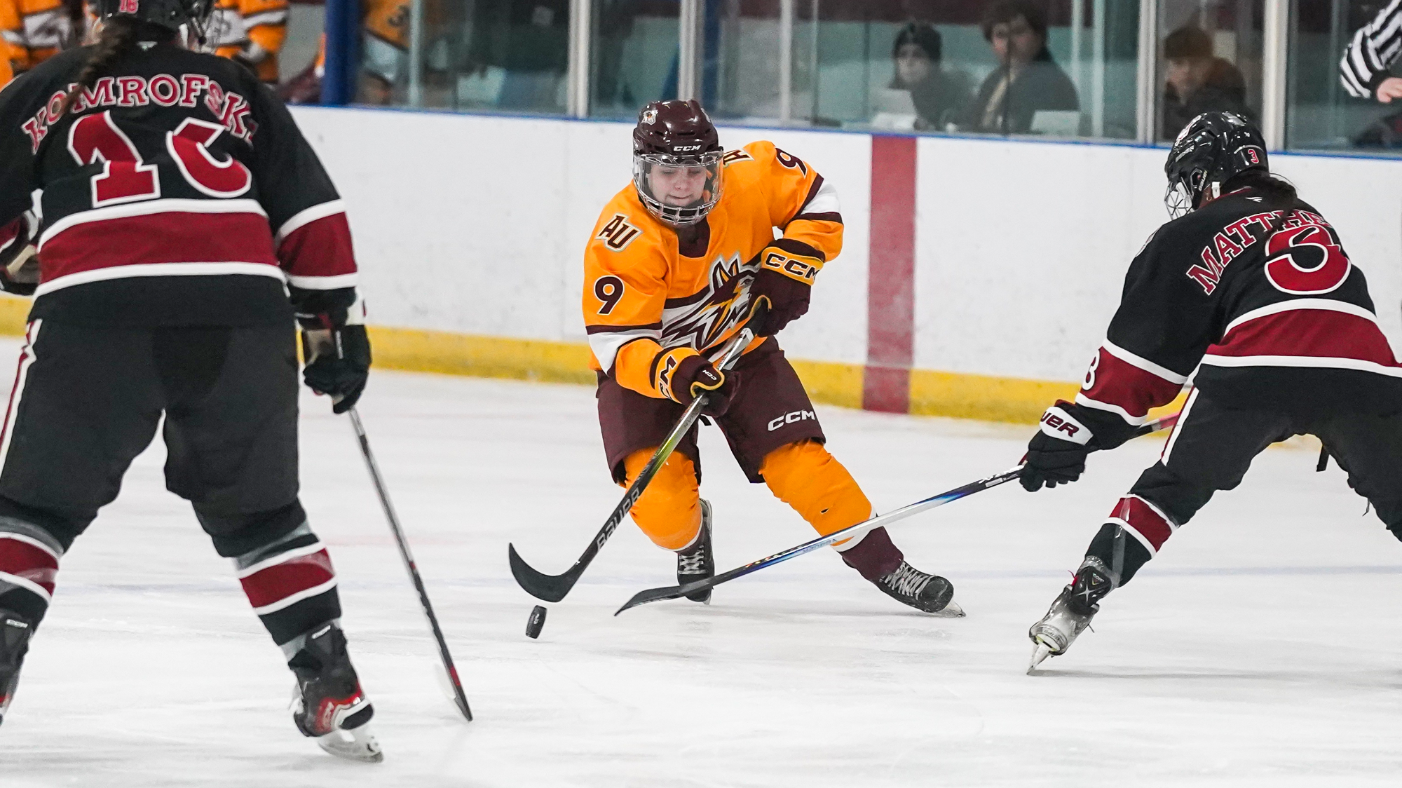 Emma Hart skates between defenders